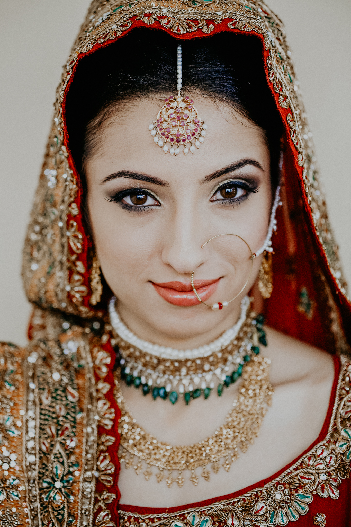 Portrait of Indian bride in red and gold dress