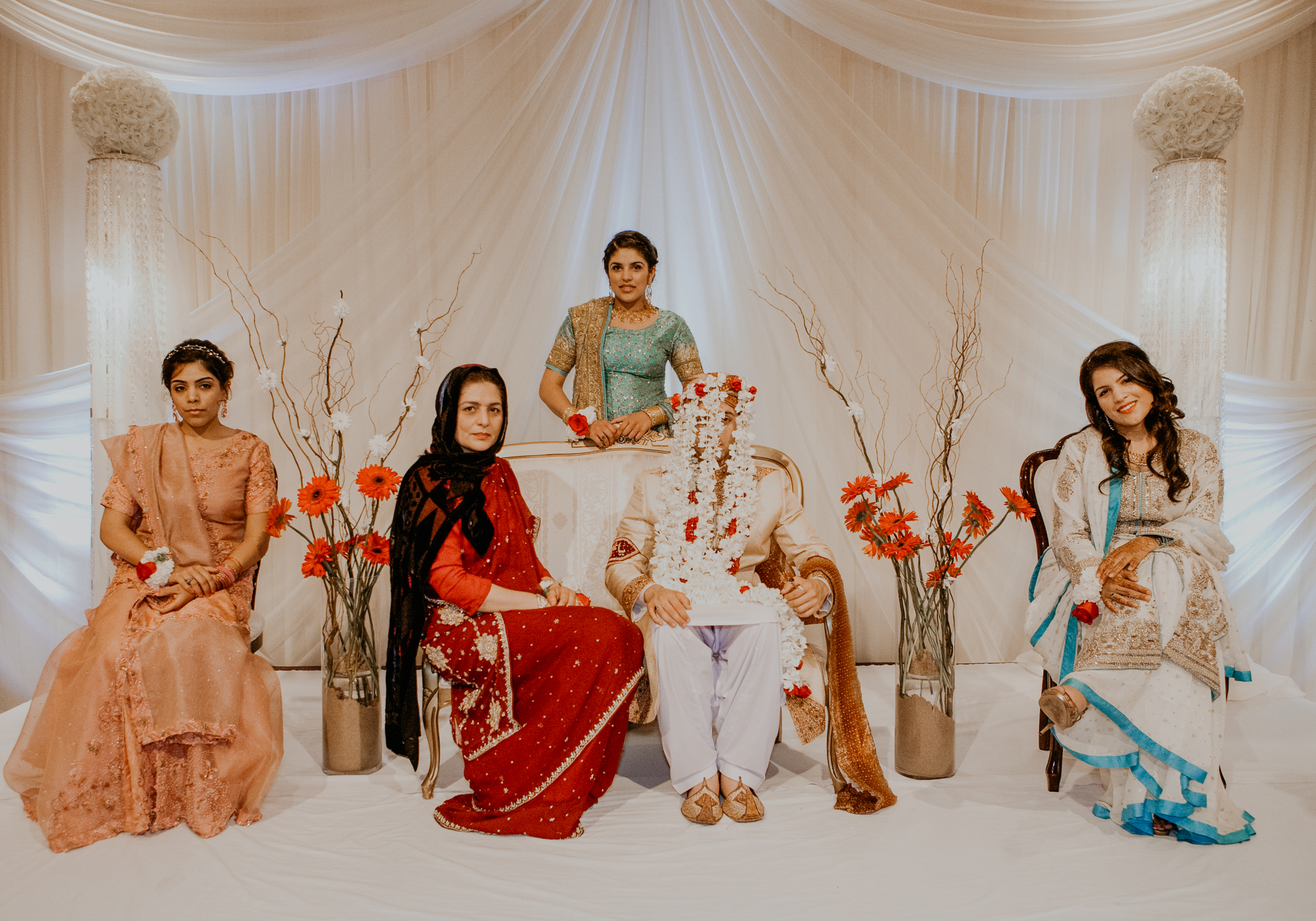 Family portrait with Indian groom in flower veil