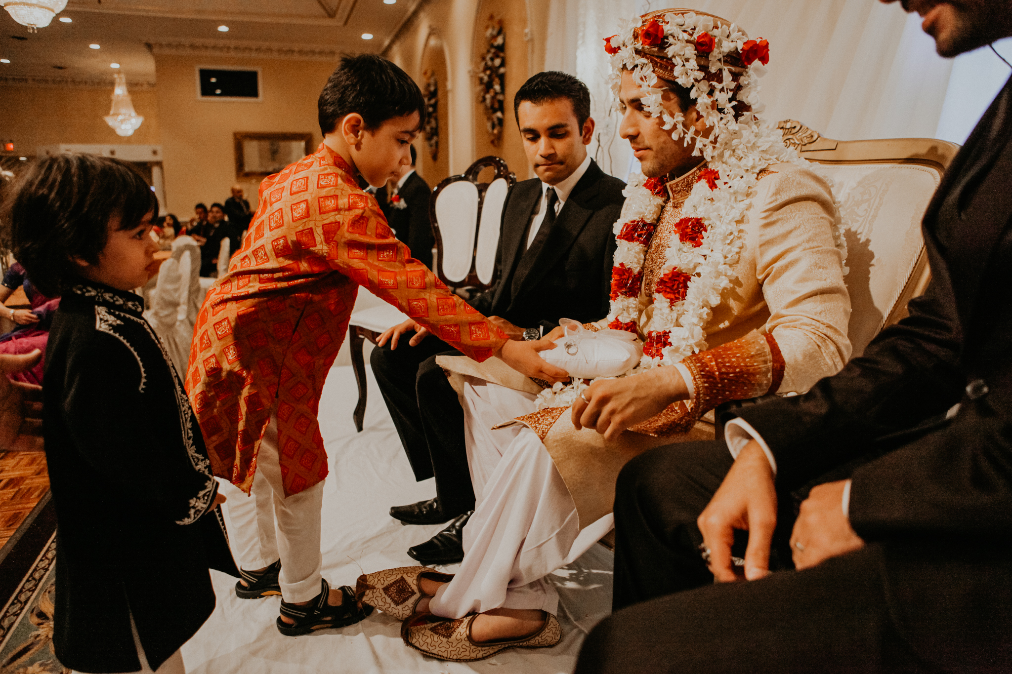 Ring bearer brings rings to groom at Mehndi
