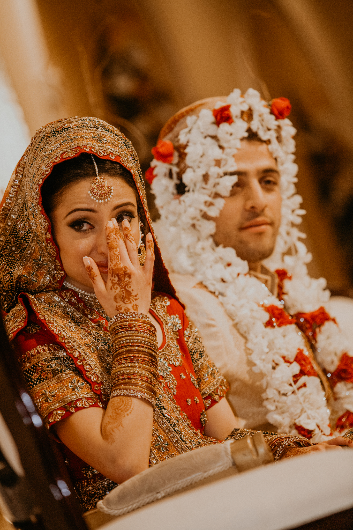 Indian bride and groom listen to speeches at Indian Mehndi wedding MN documentary photographer