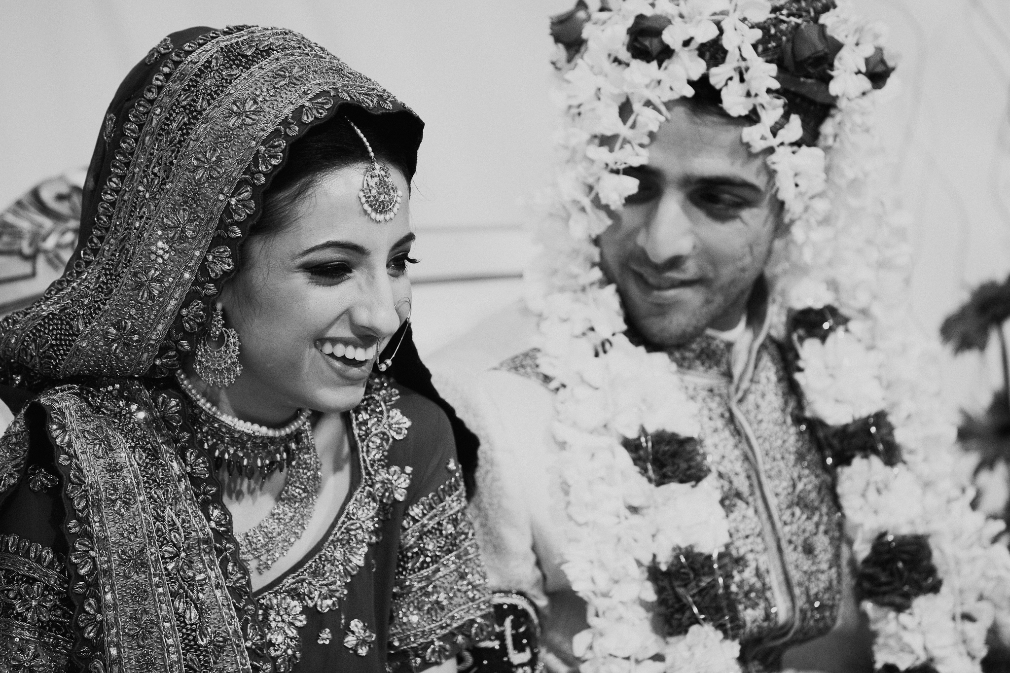 Indian bride and groom laugh during speeches at Indian Mehndi wedding MN documentary photographer