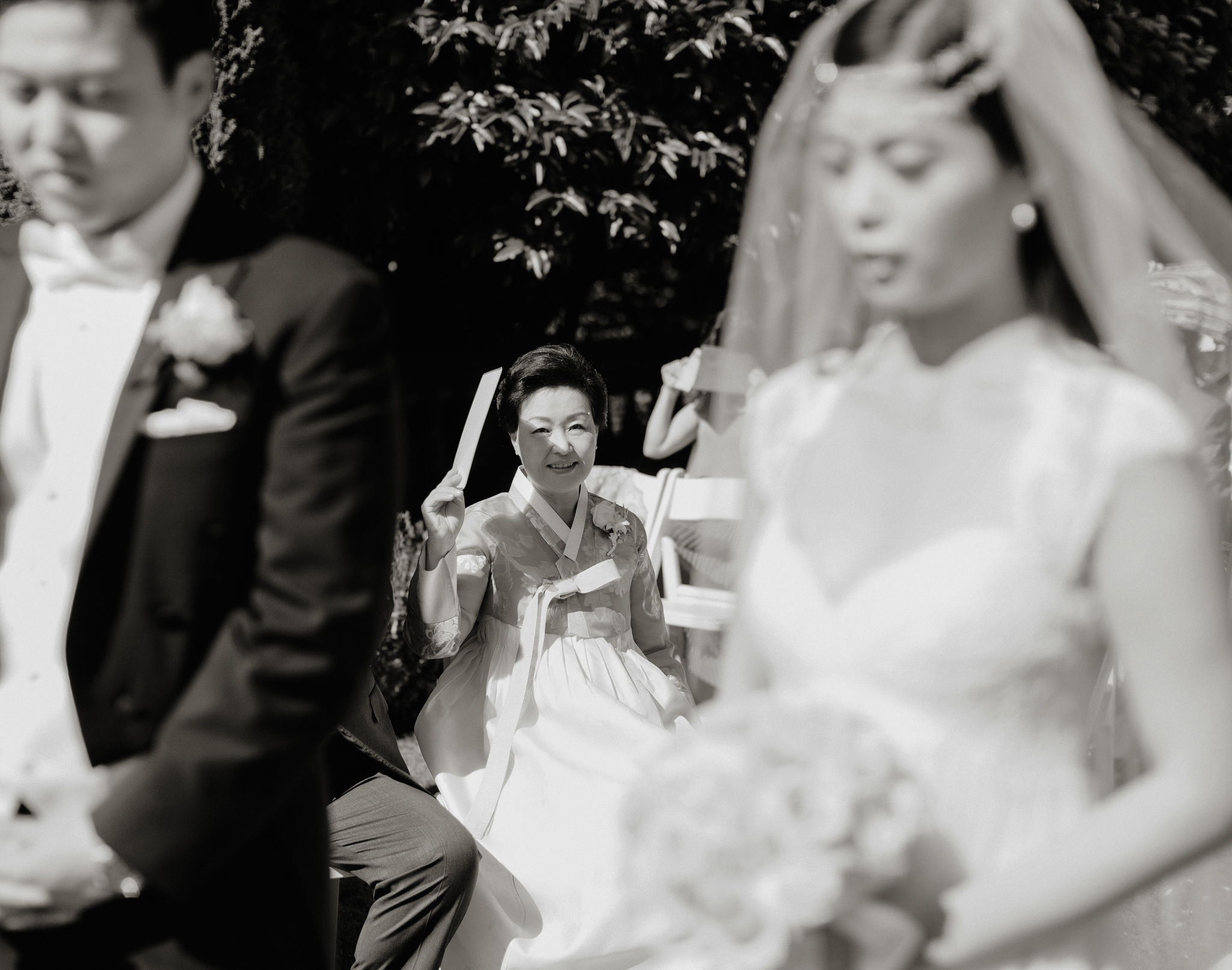 Mother watches bride and groom exchange vows in Korean wedding ceremony