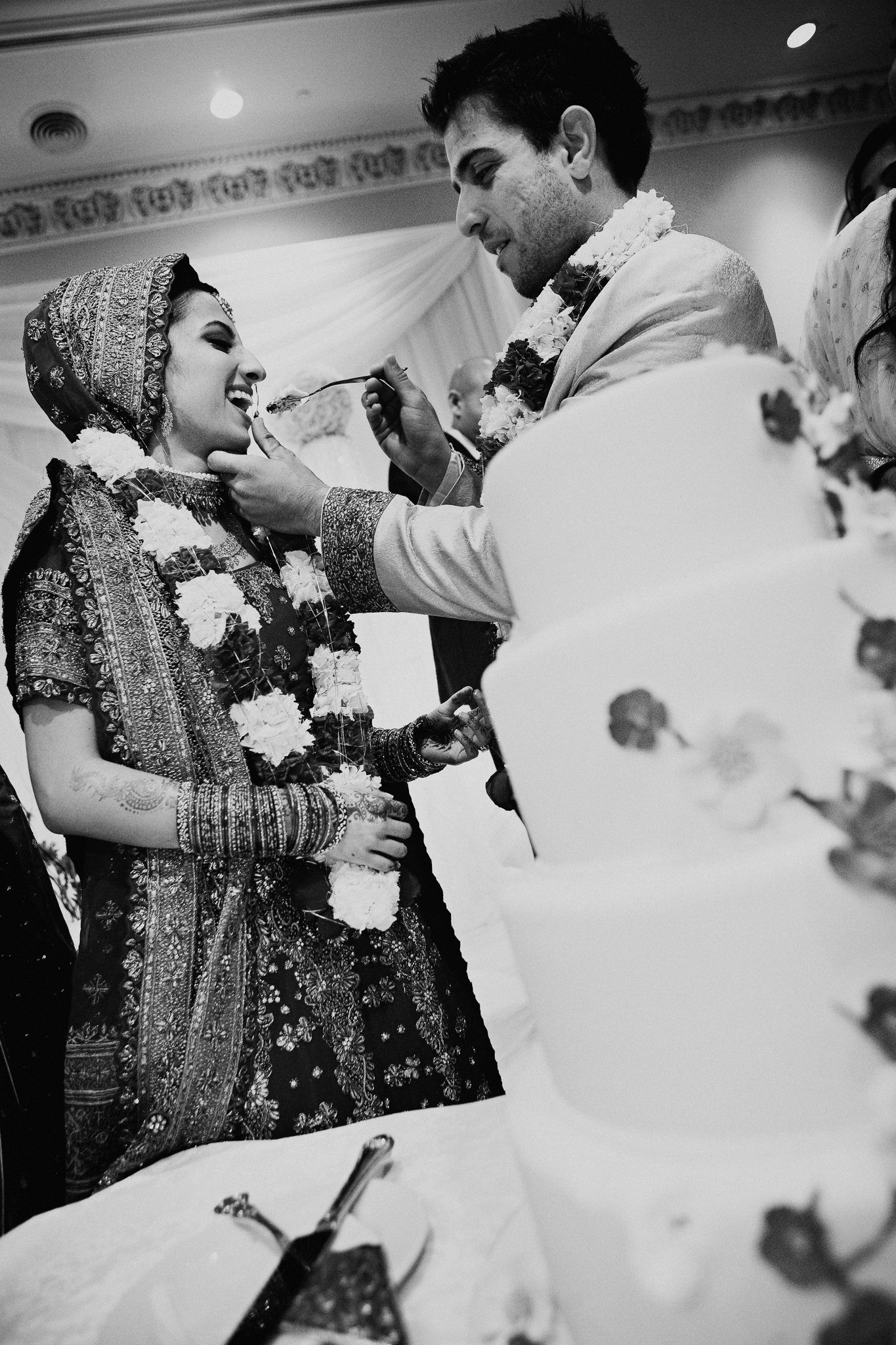 Bride and groom each cake at Mehndi Indian Islamic wedding MN documentary photograph