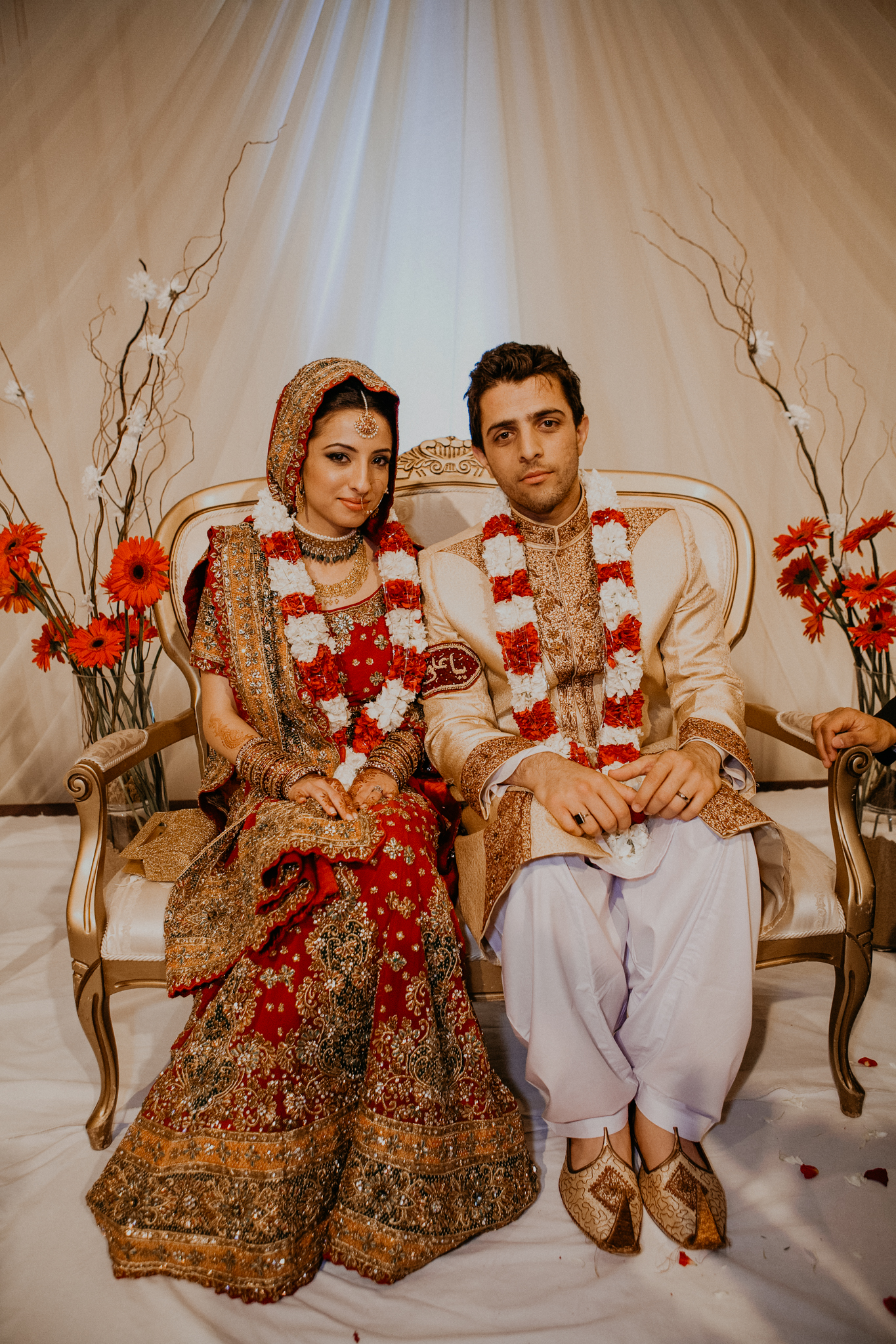 Bride and groom smile at Mehndi wedding celebration