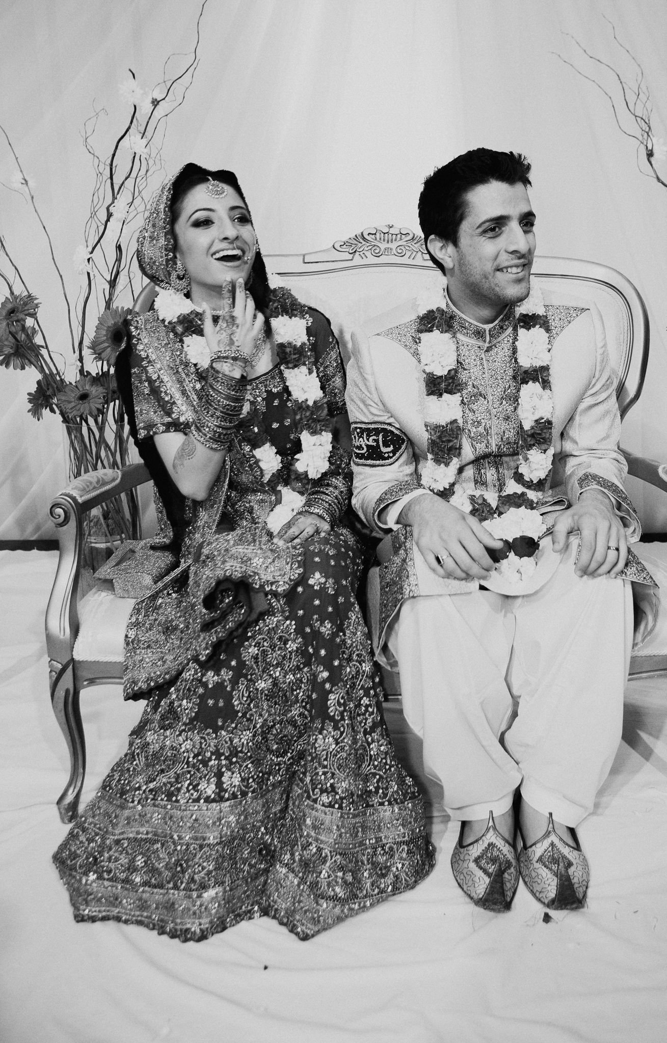Bride and groom smile at Mehndi wedding celebration