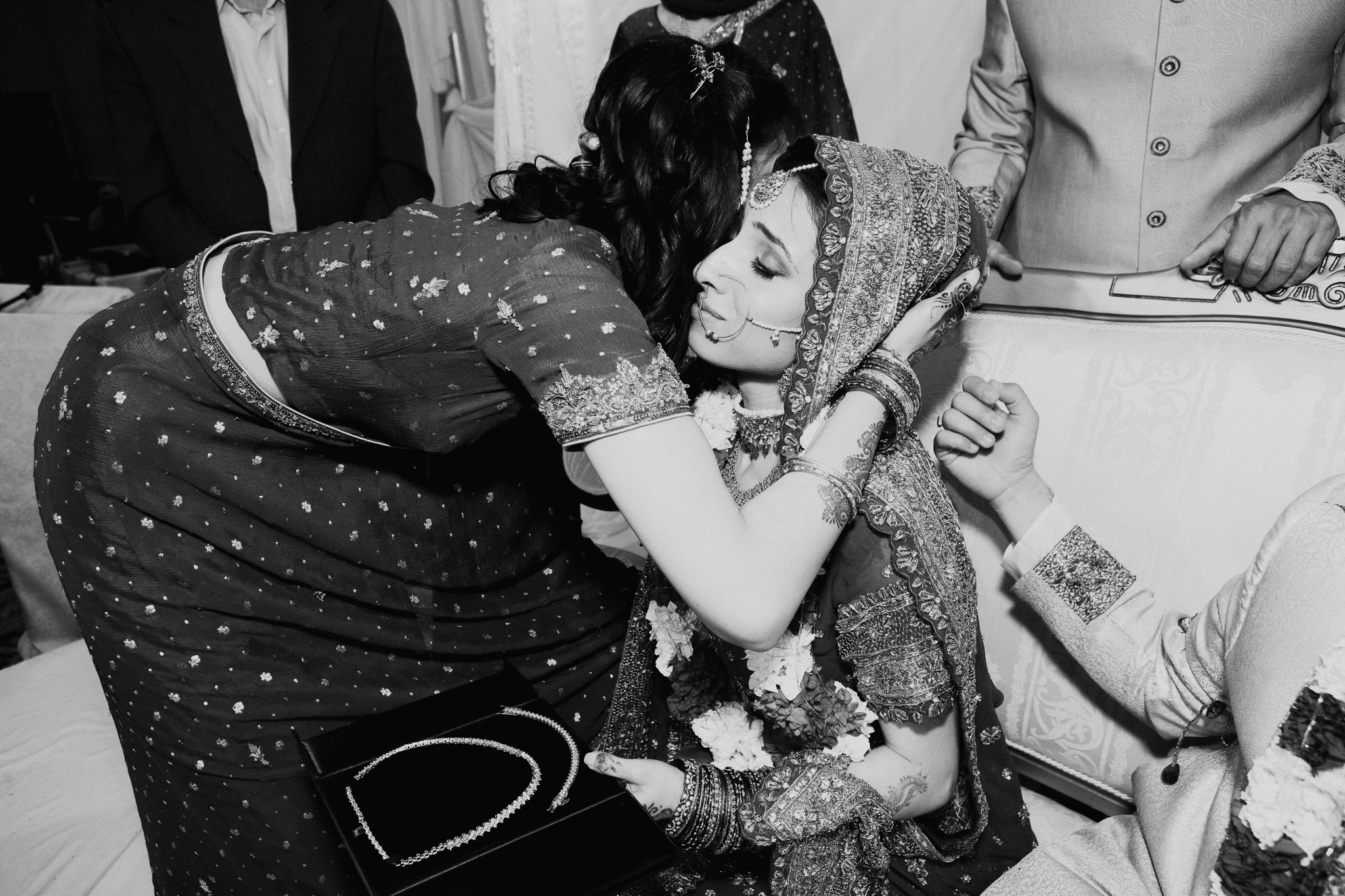 Sister hugs bride during Mehndi Indian wedding MN documentary wedding photo
