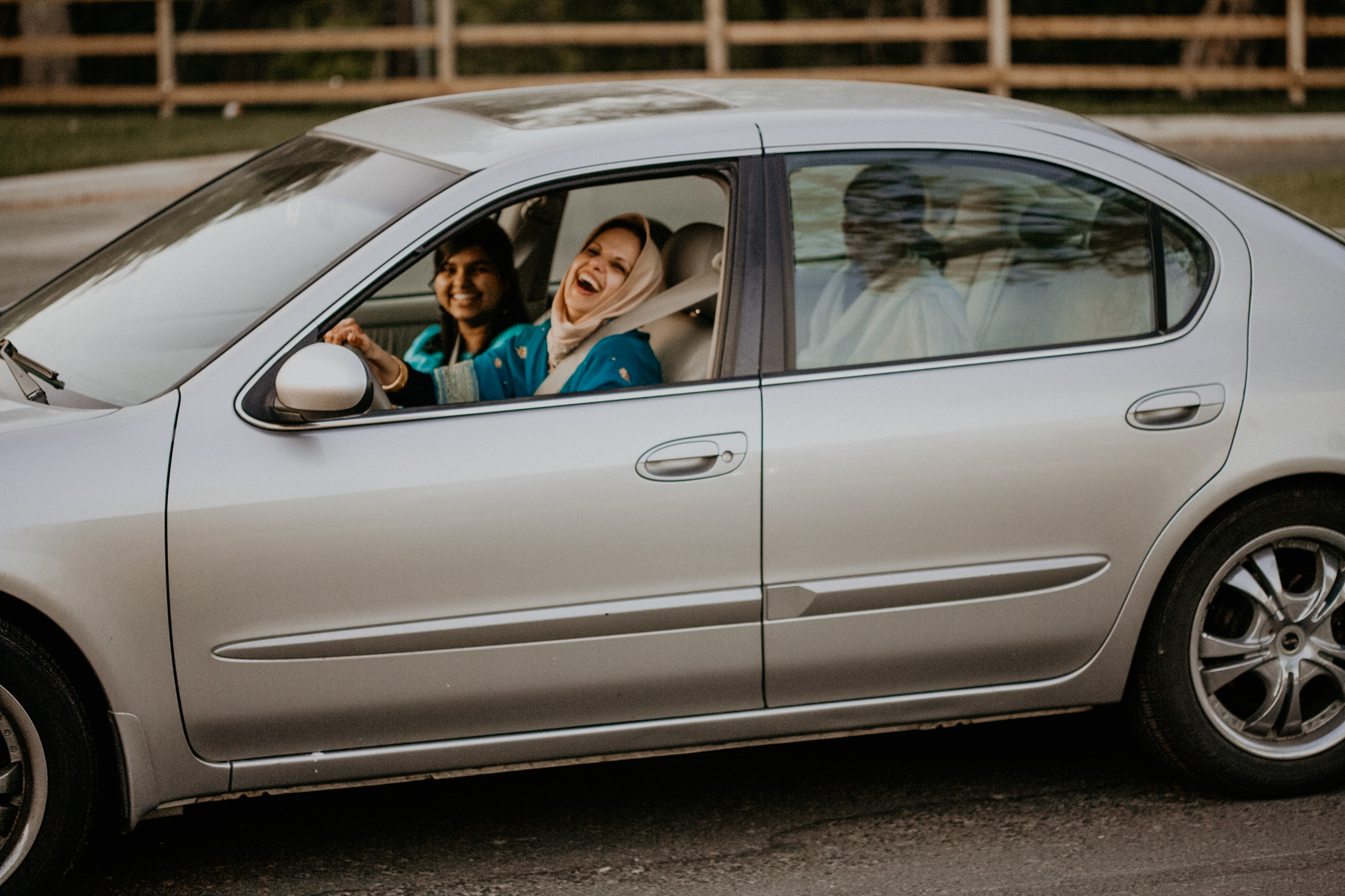 Candid photo of mother of bride arriving in car to ceremony