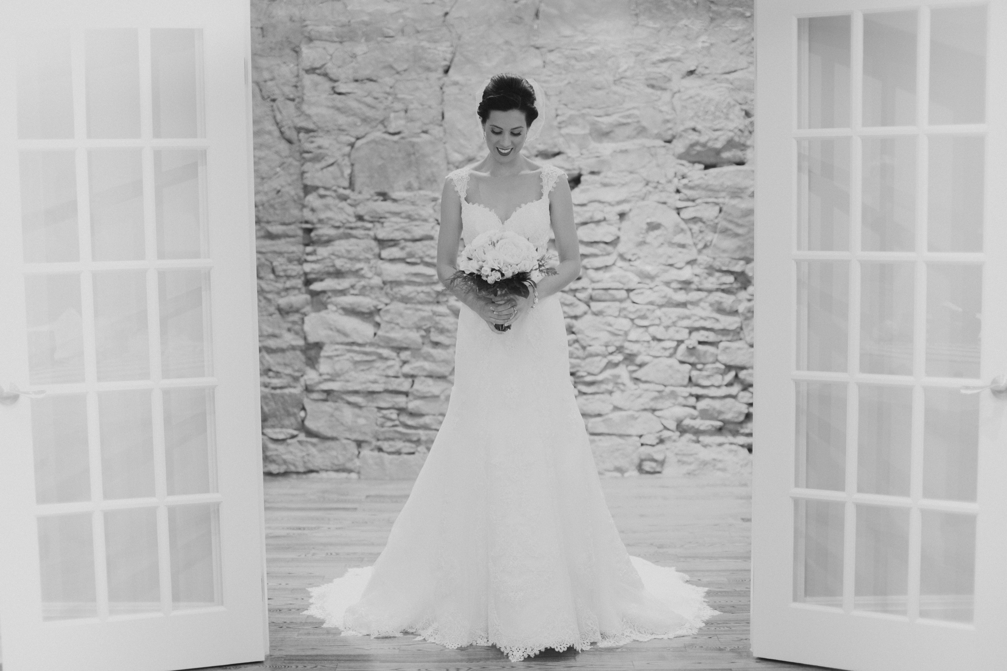 Portrait of bride in wedding dress framed by doorway