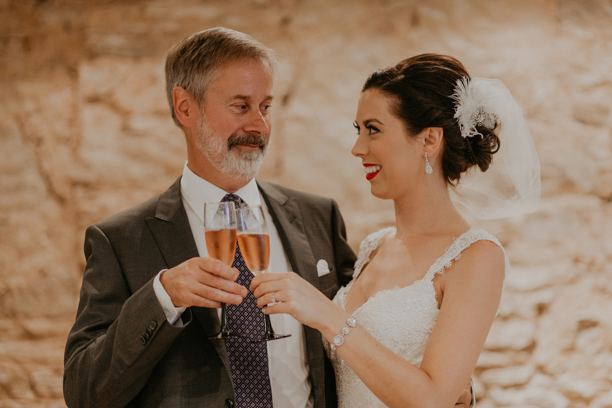 Father of the bride toasts bride during getting ready pictures