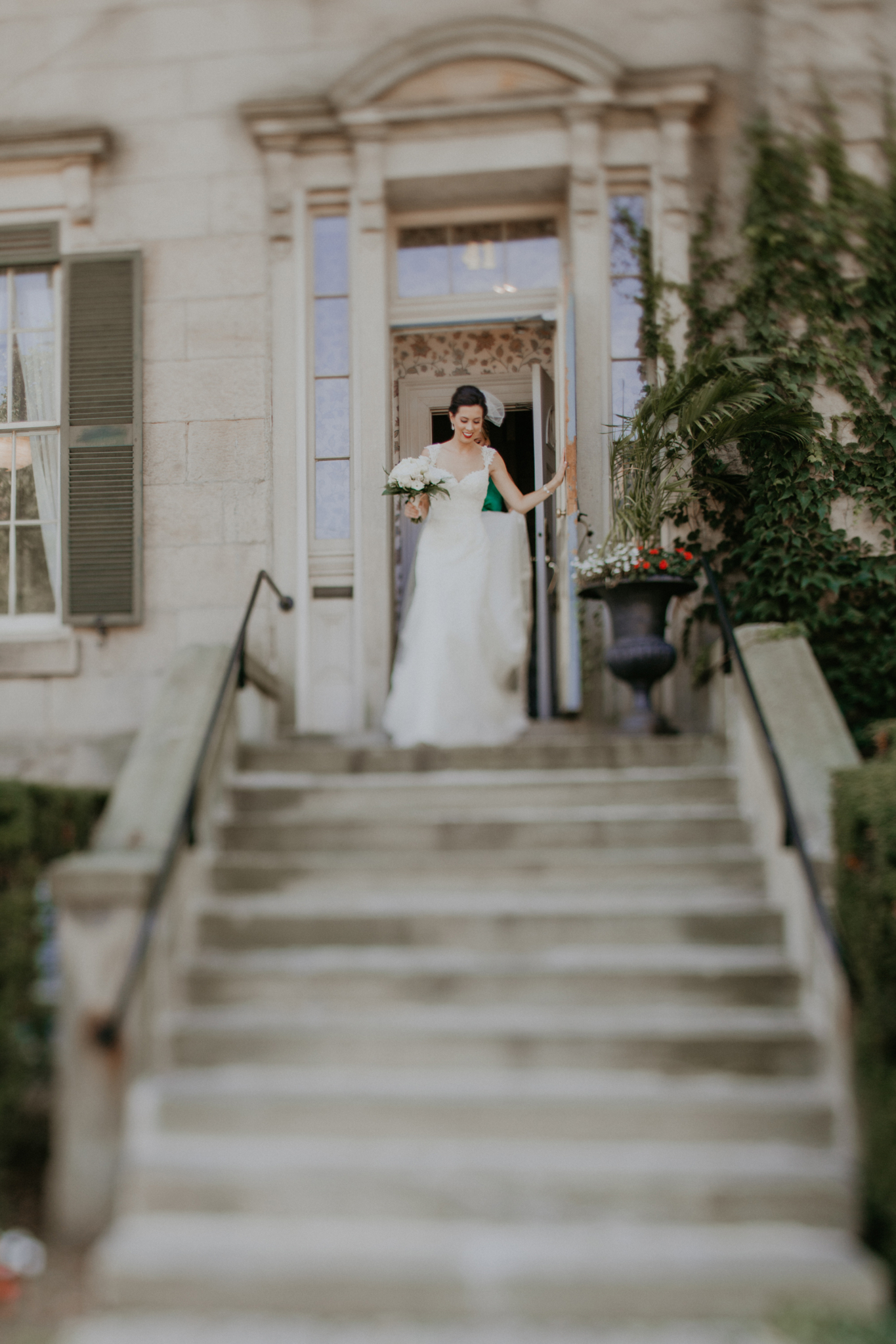 Bride walking down steps with bridesmaid on wedding day