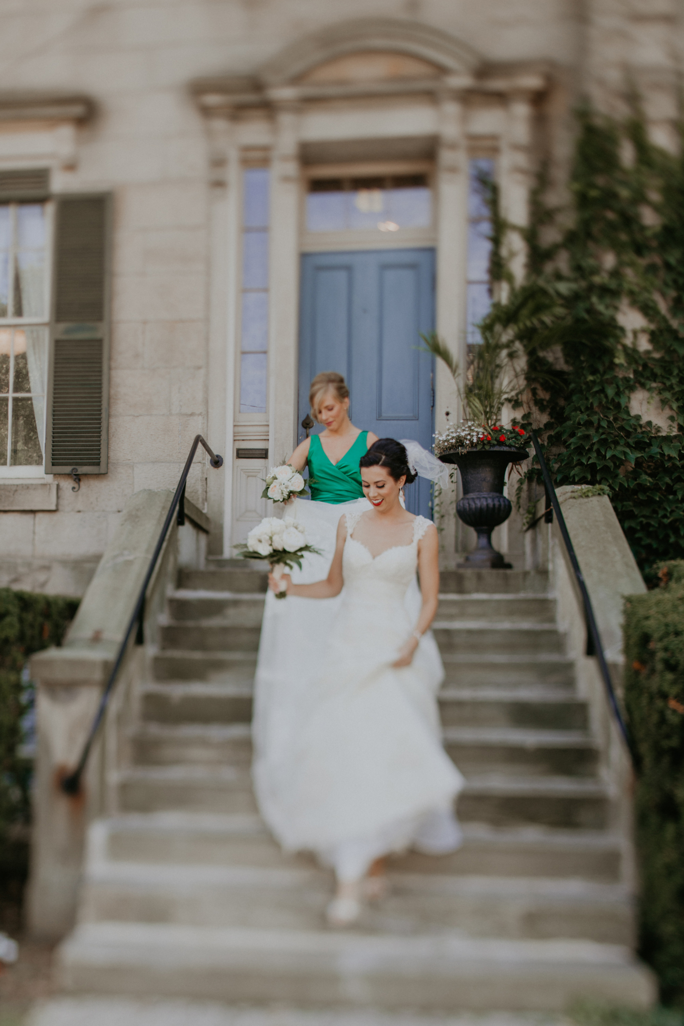Bride walking down steps with bridesmaid on wedding day