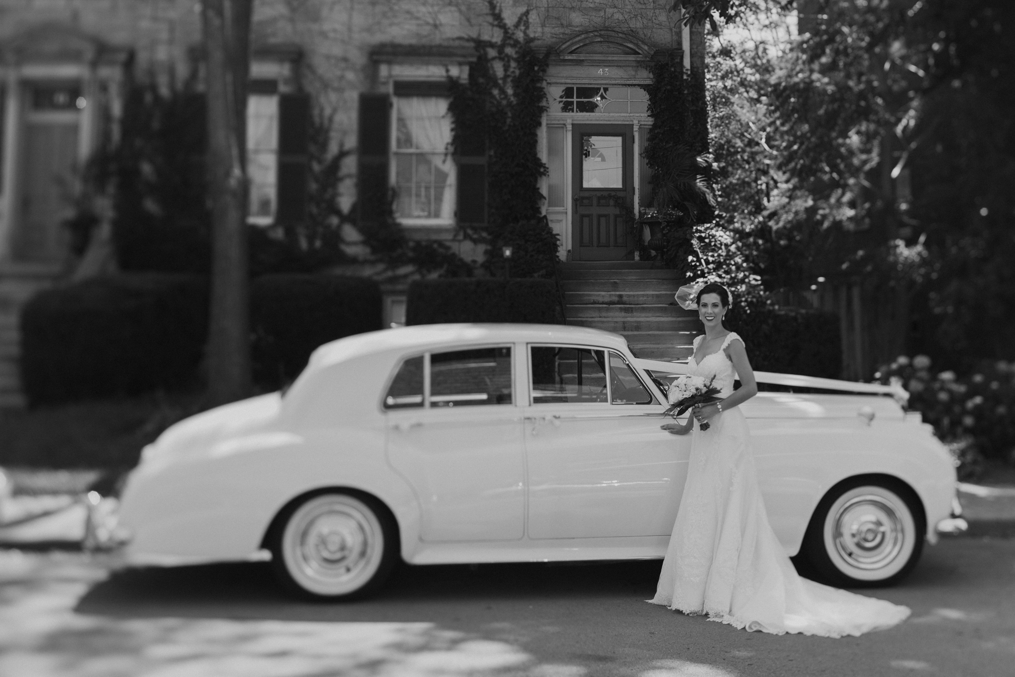 Portrait of bride in front of Rolls Royce
