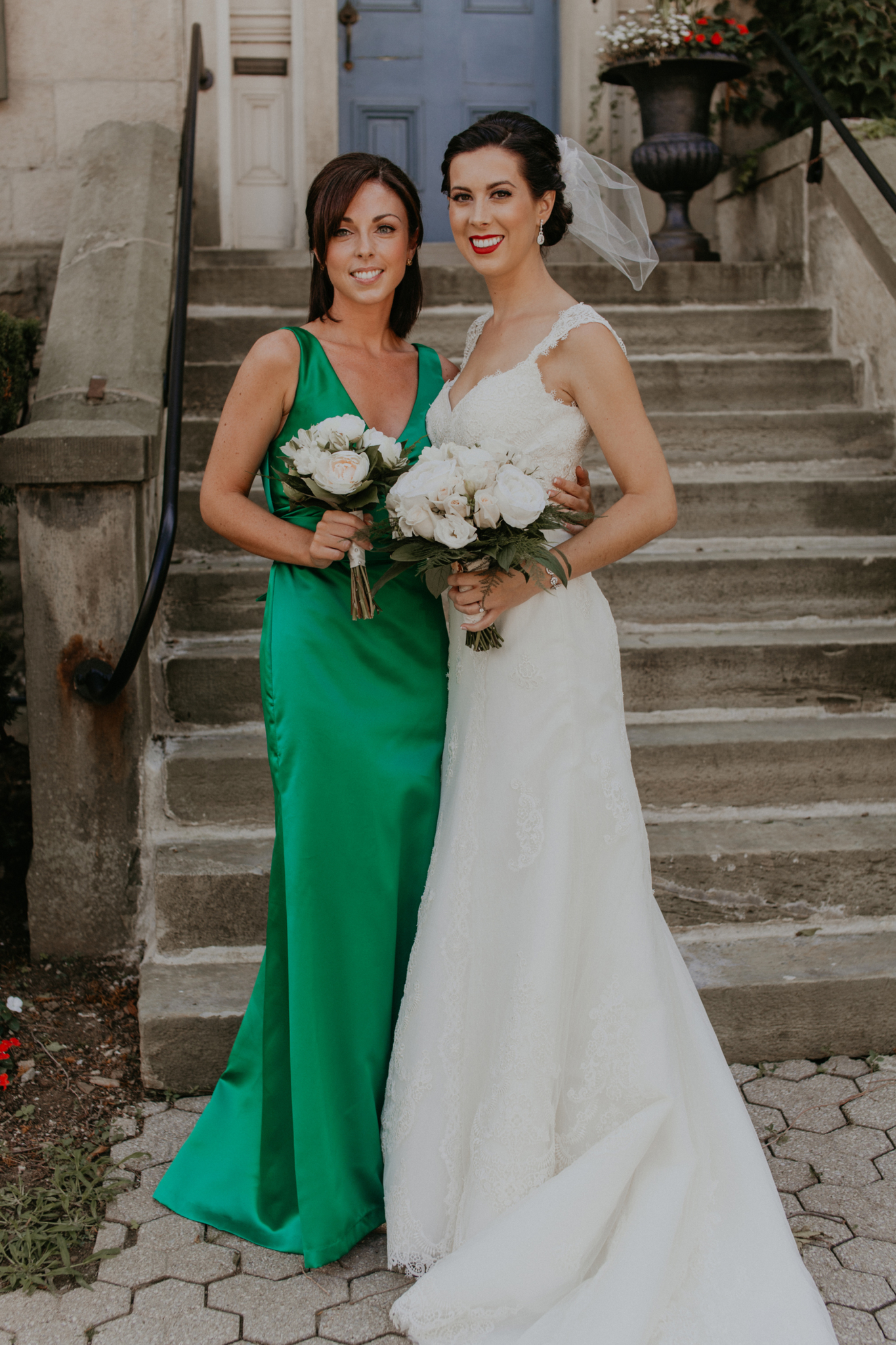 Portrait of bride with bridesmaid in green dress