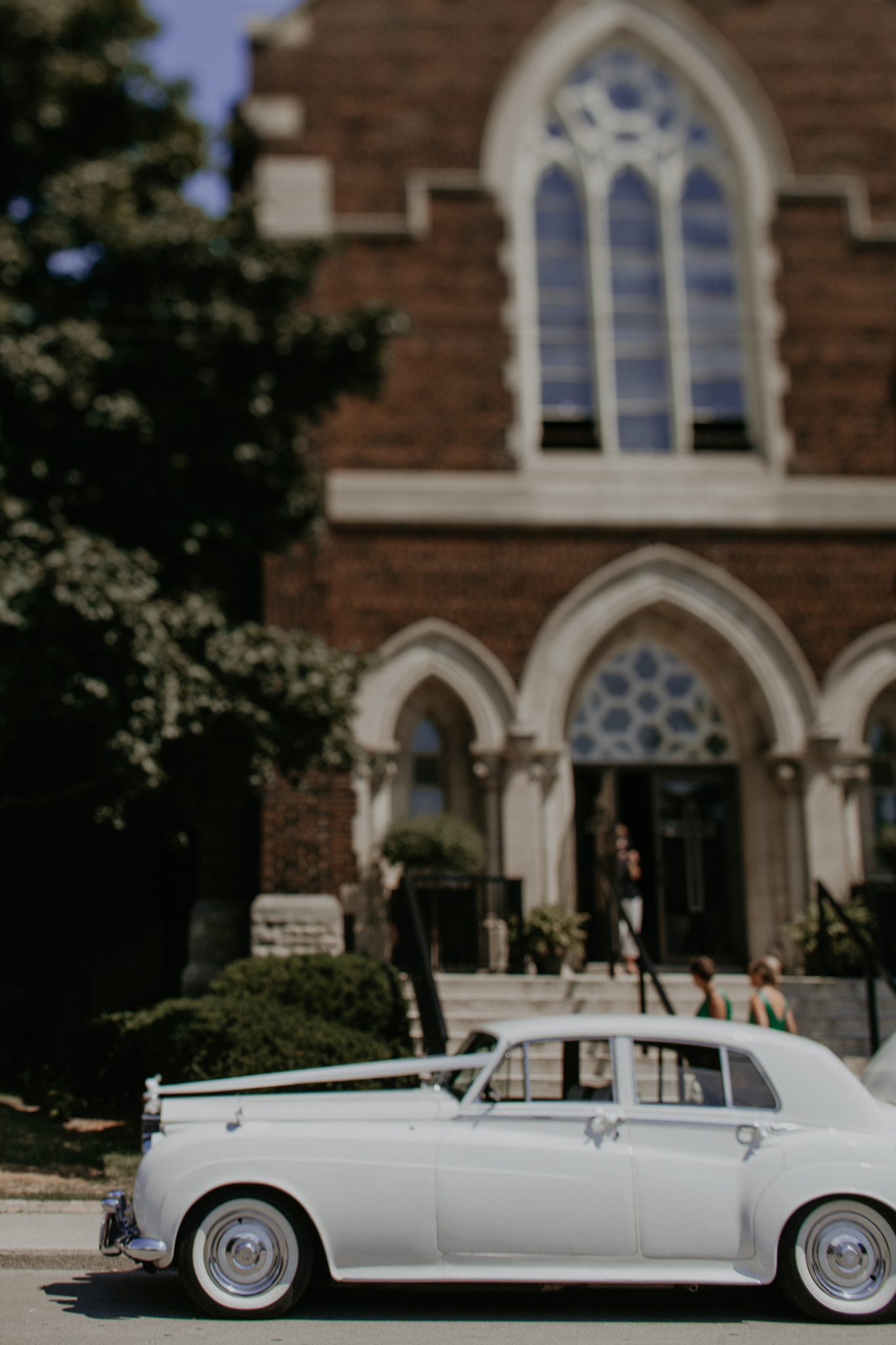 Rolls Royce parked outside church at wedding ceremony