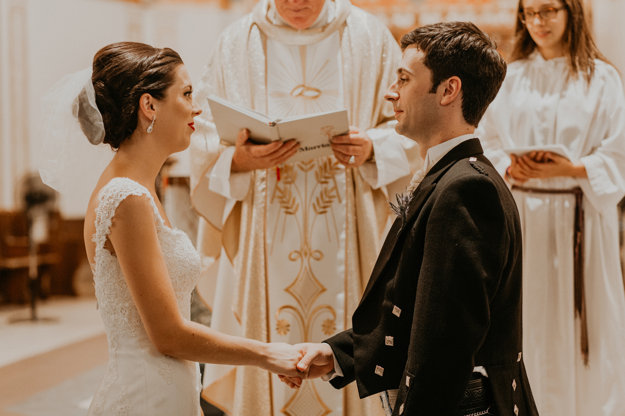 Bride and groom exchange vows in church wedding ceremony