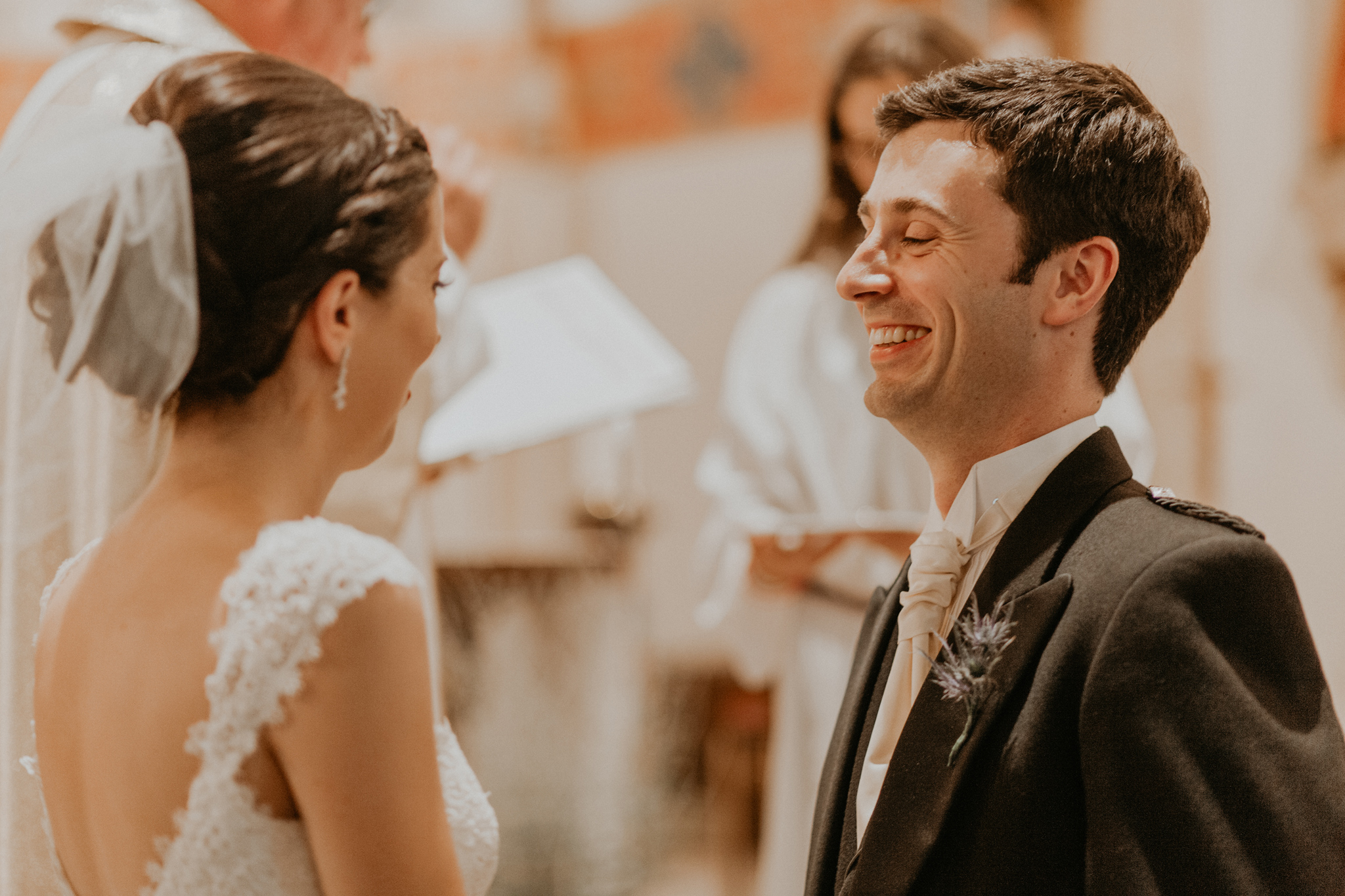 Bride and groom laughing during church wedding ceremony