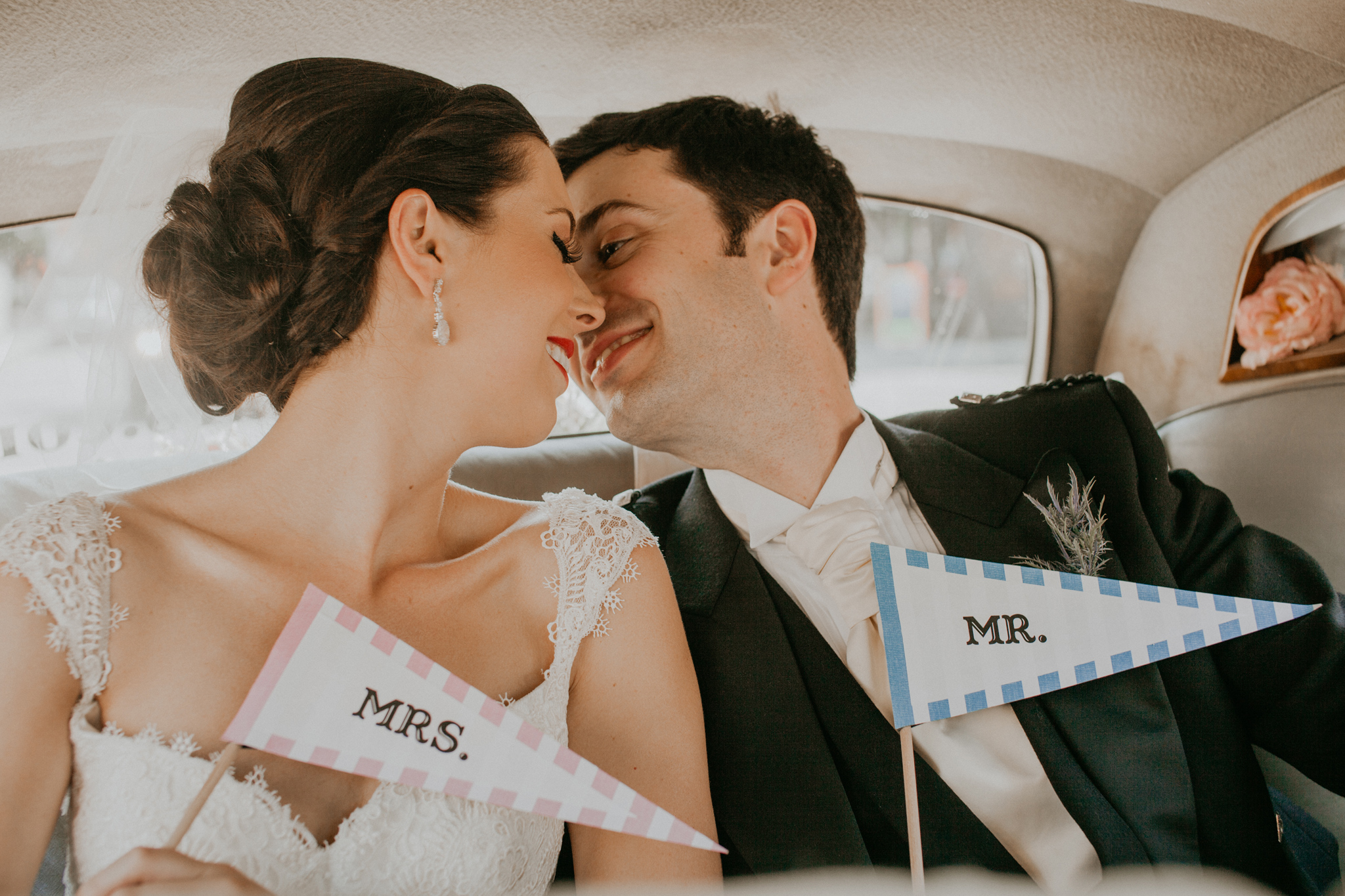 Couple of bride and groom kissing in car