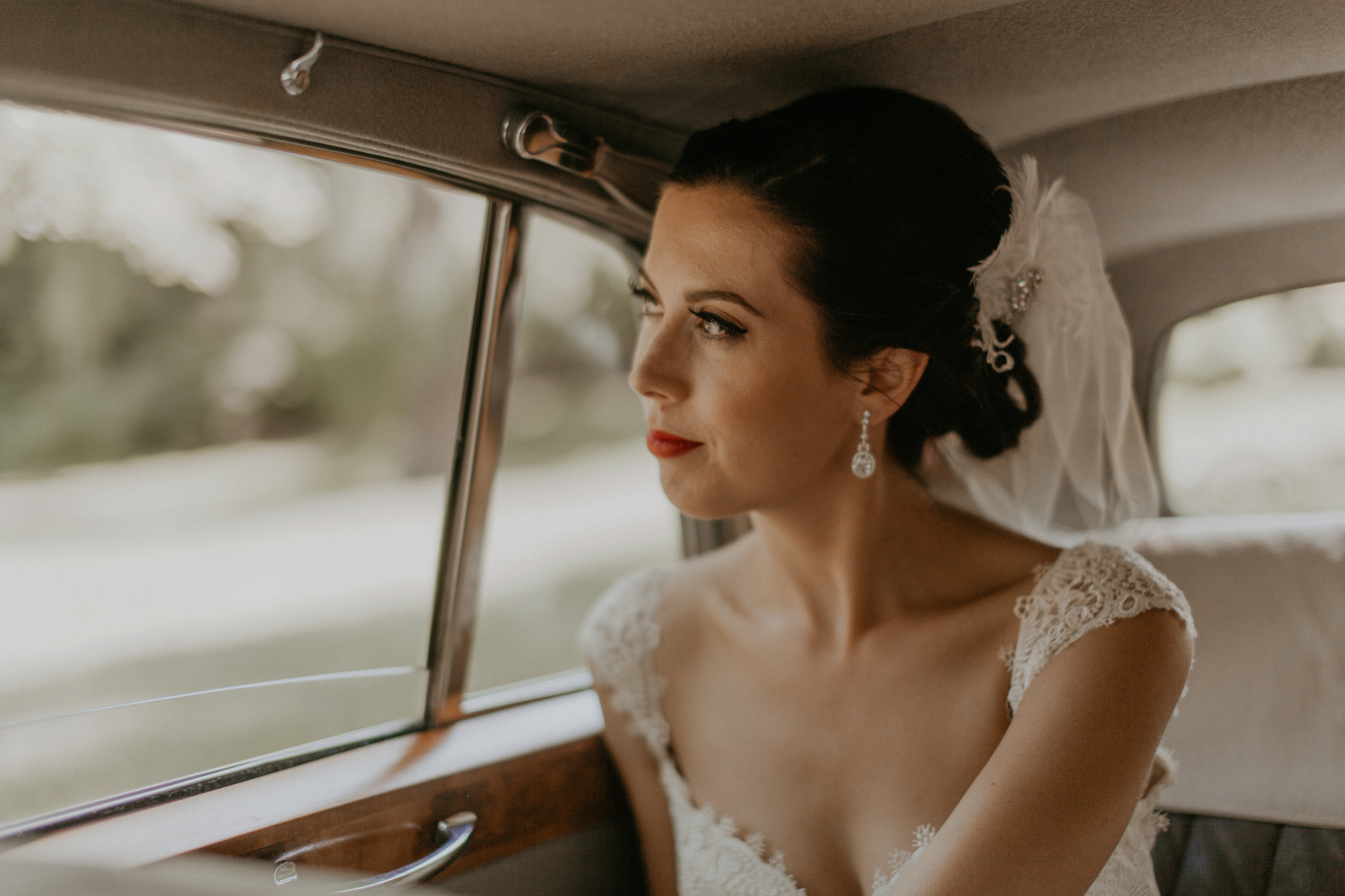 Candid documentary photo of bride riding in car