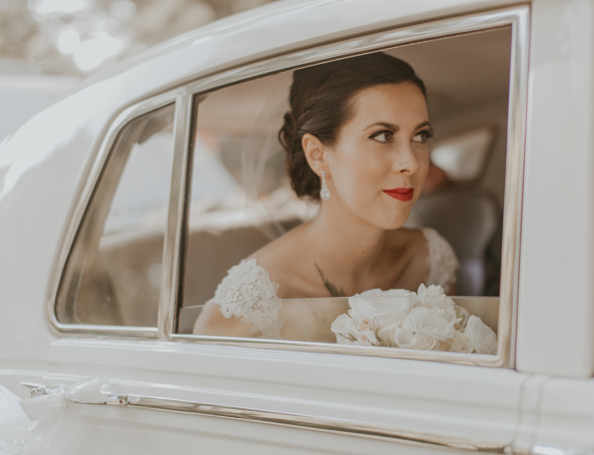 Picture of bride in car window on wedding day