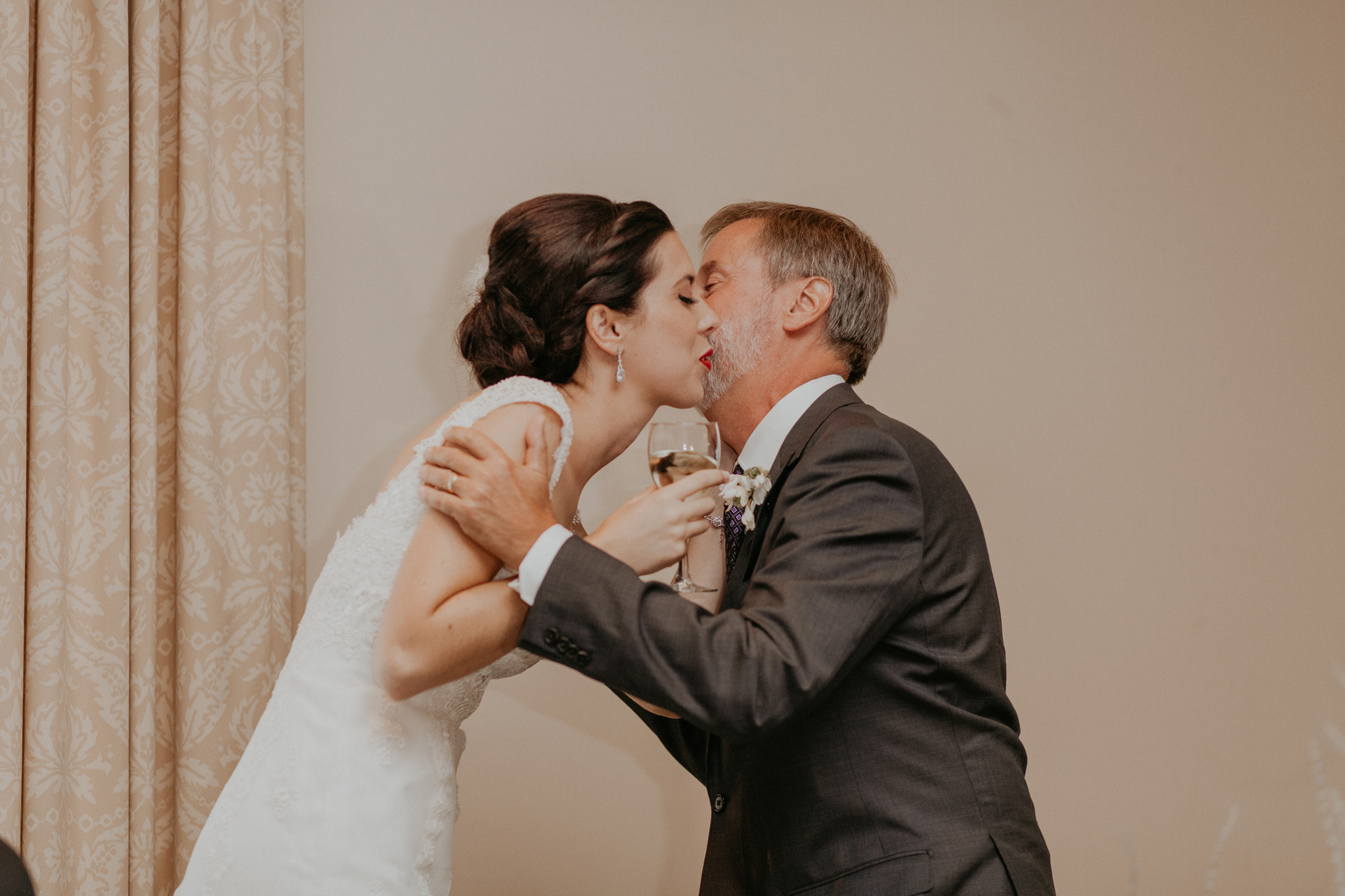 Bride kisses father after wedding speech in documentary wedding photo