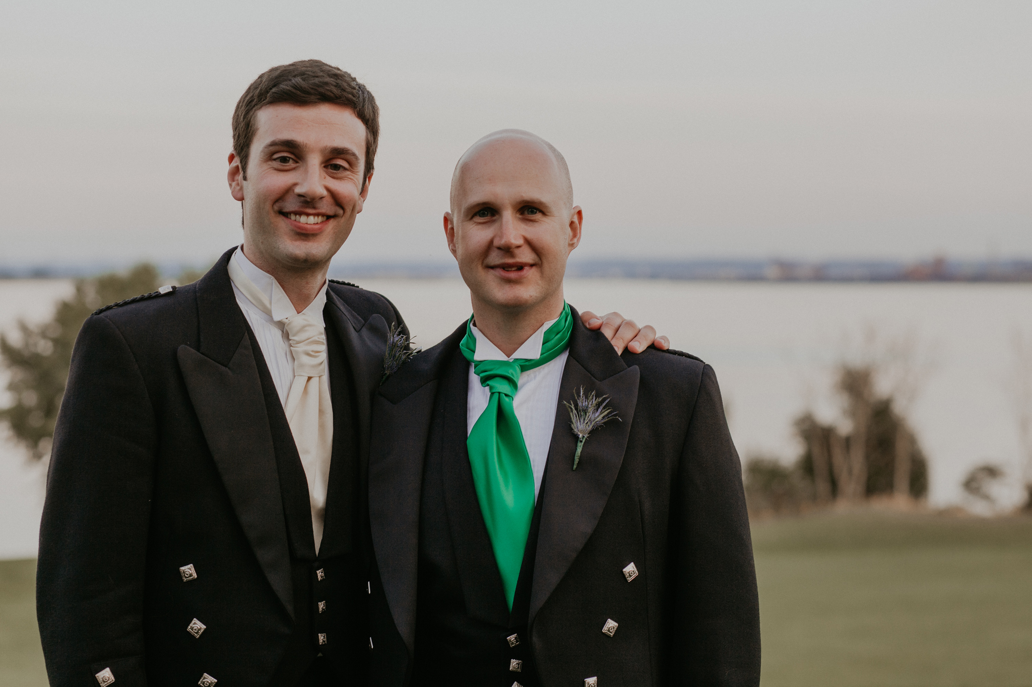 Portrait of groom with best man smiling