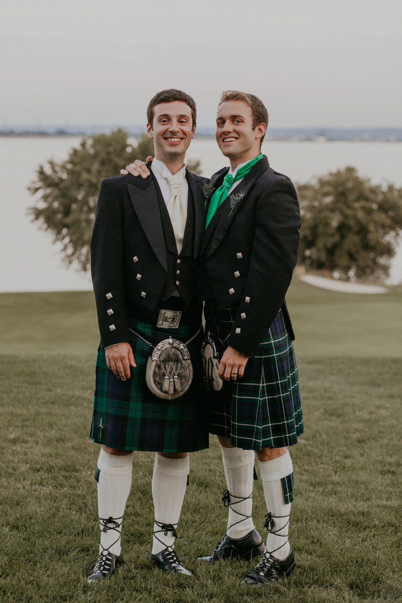 Portrait of groom with groomsman smiling