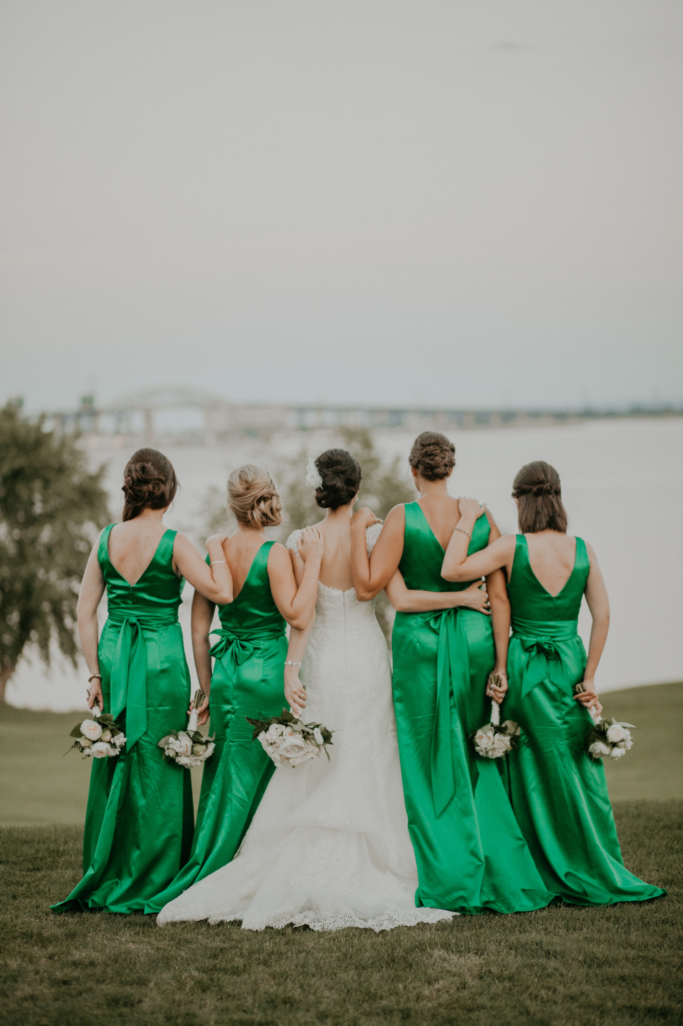 Portrait of bride and bridesmaids in green bridesmaids gowns