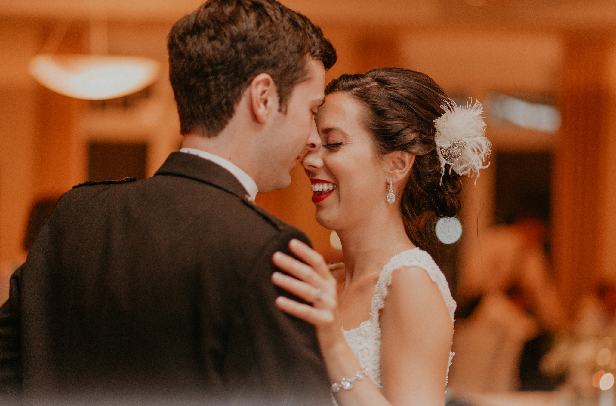 Bride and groom smile in candid documentary photograph picture during wedding reception 