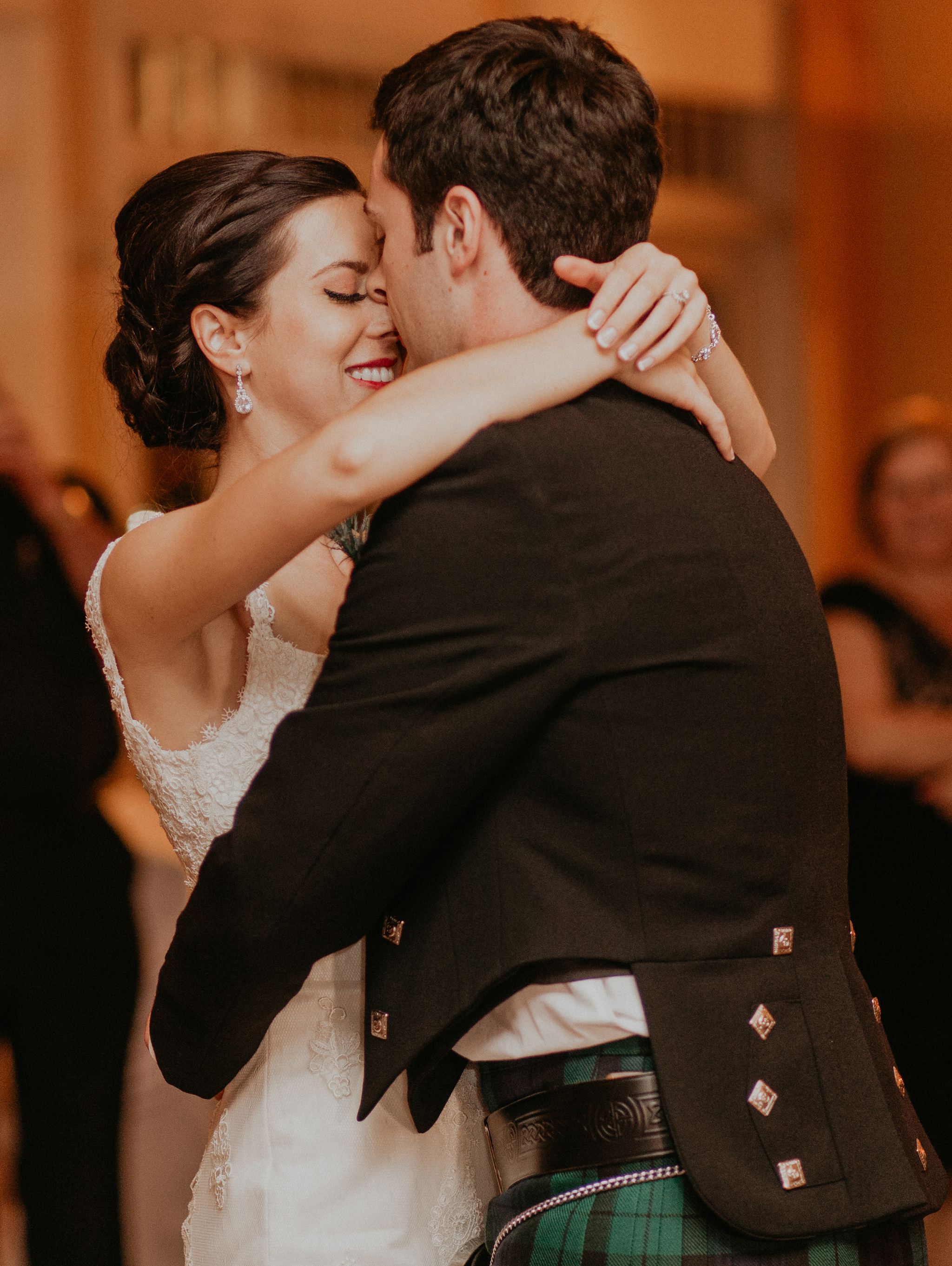 Candid photo of bride and groom hugging during first dance romantic wedding picture