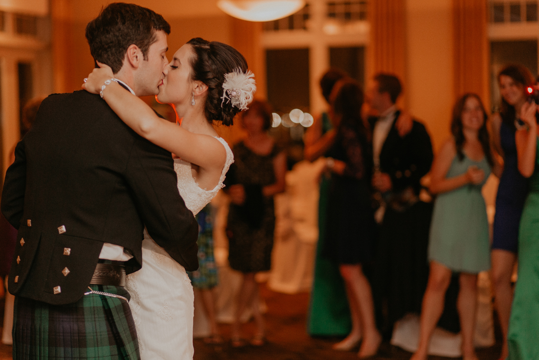 Candid photo of bride and groom kissing during first dance documentary wedding picture