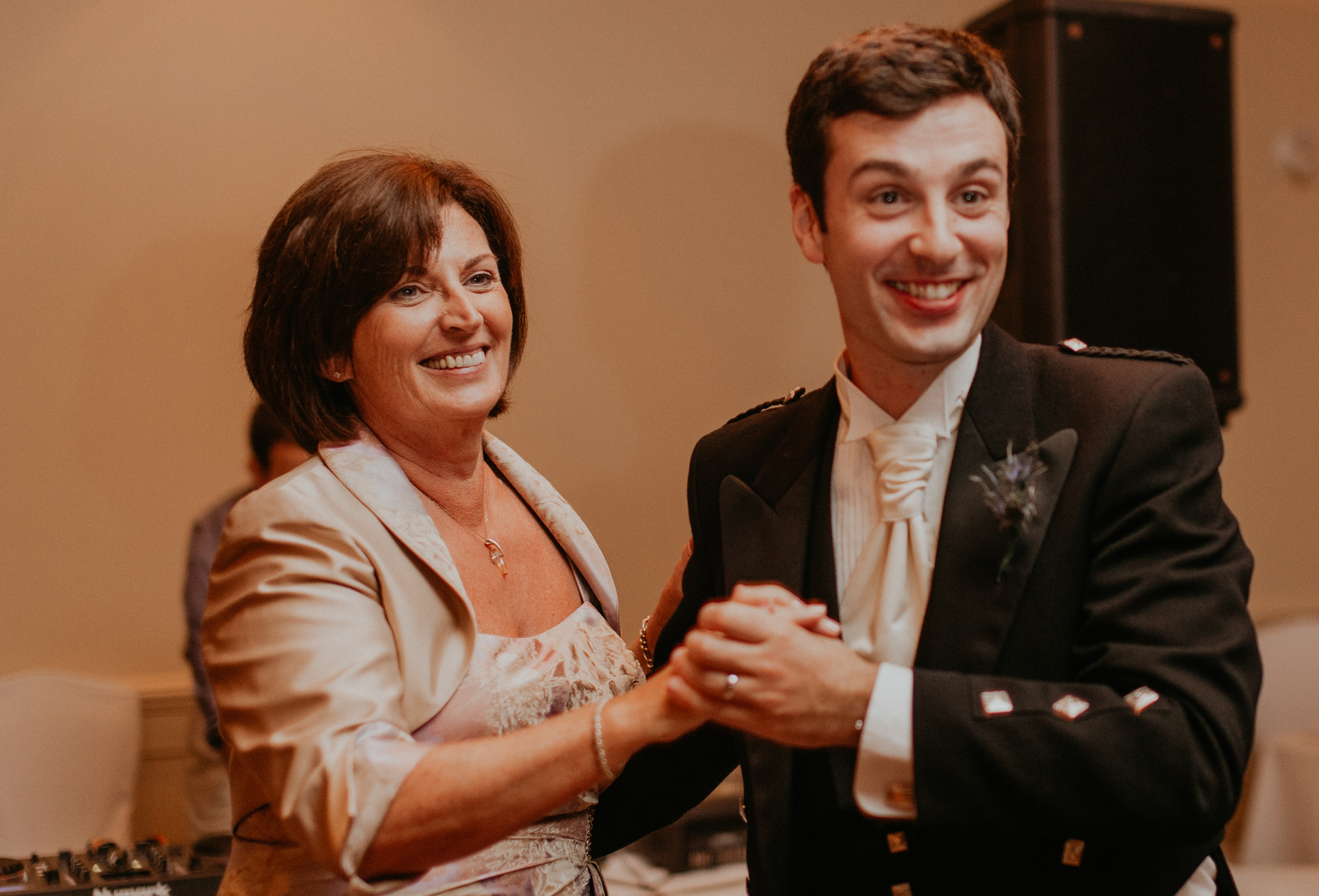 Groom dances with mom at wedding reception
