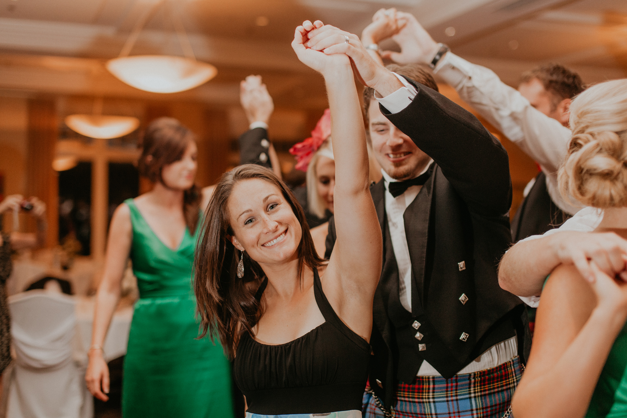Guests smile and dance at wedding