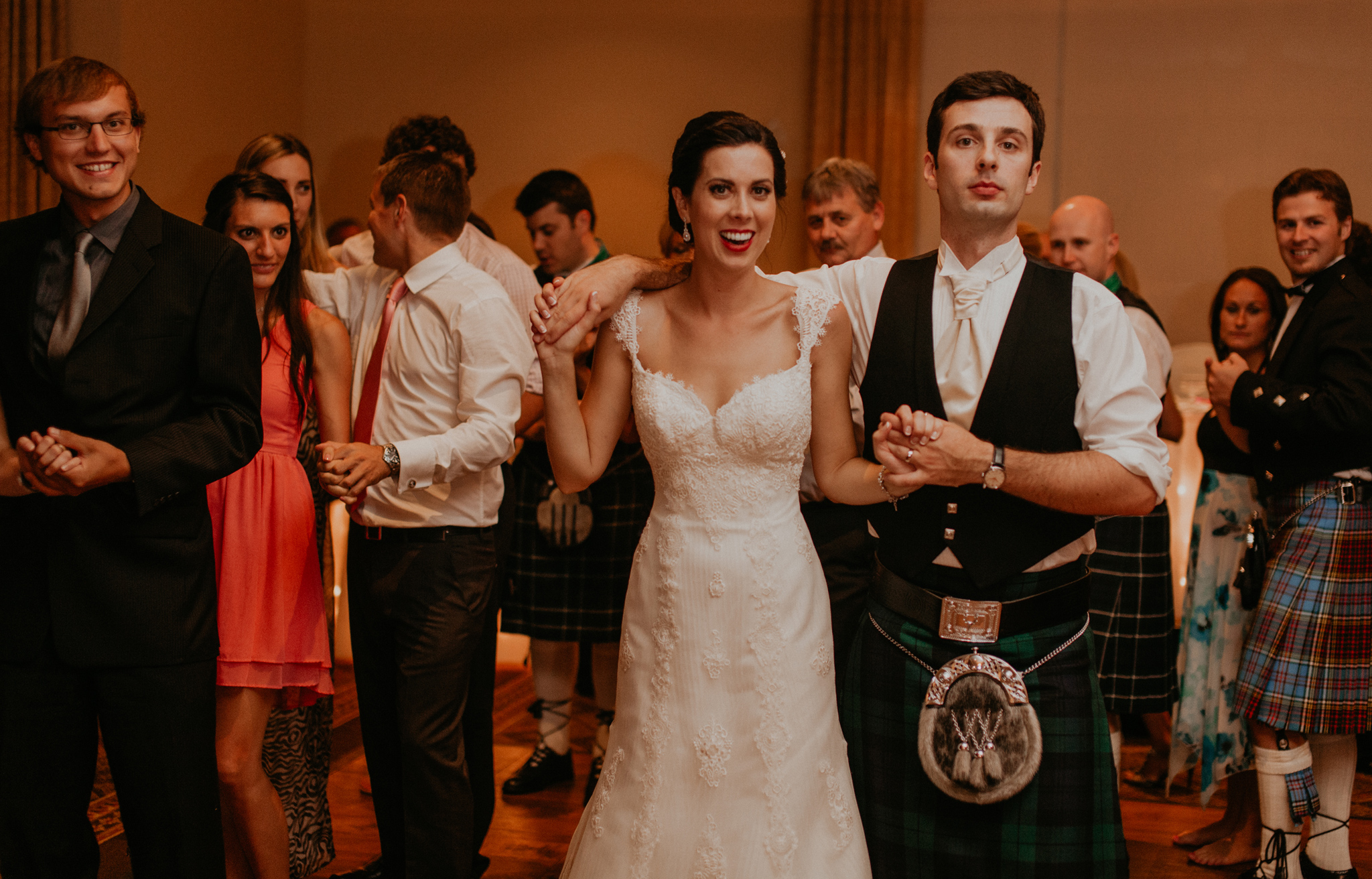 Scottish bride and groom do a traditional dance in kilt