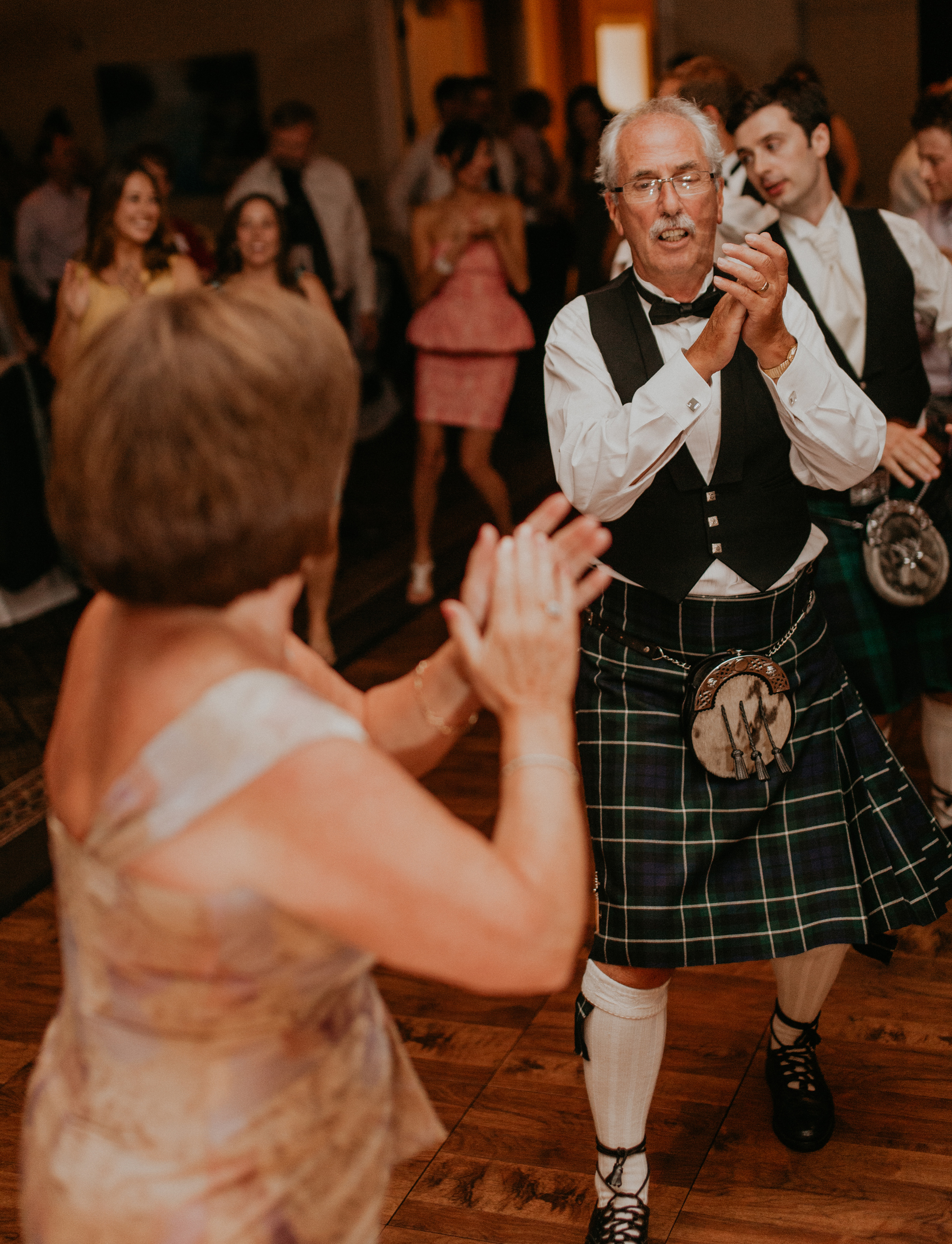 Father of the groom dances in kilt at wedding reception