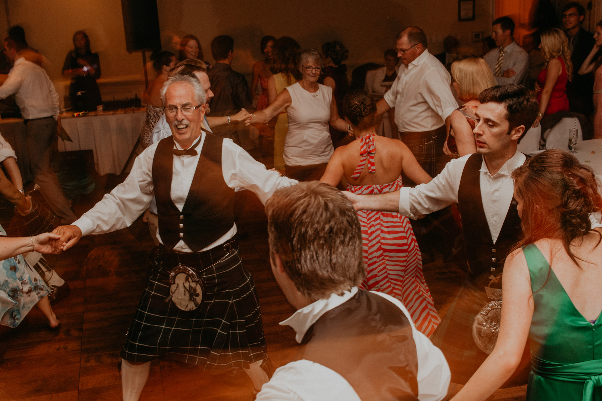 Guests dance in kilts at wedding reception candid documentary wedding photography