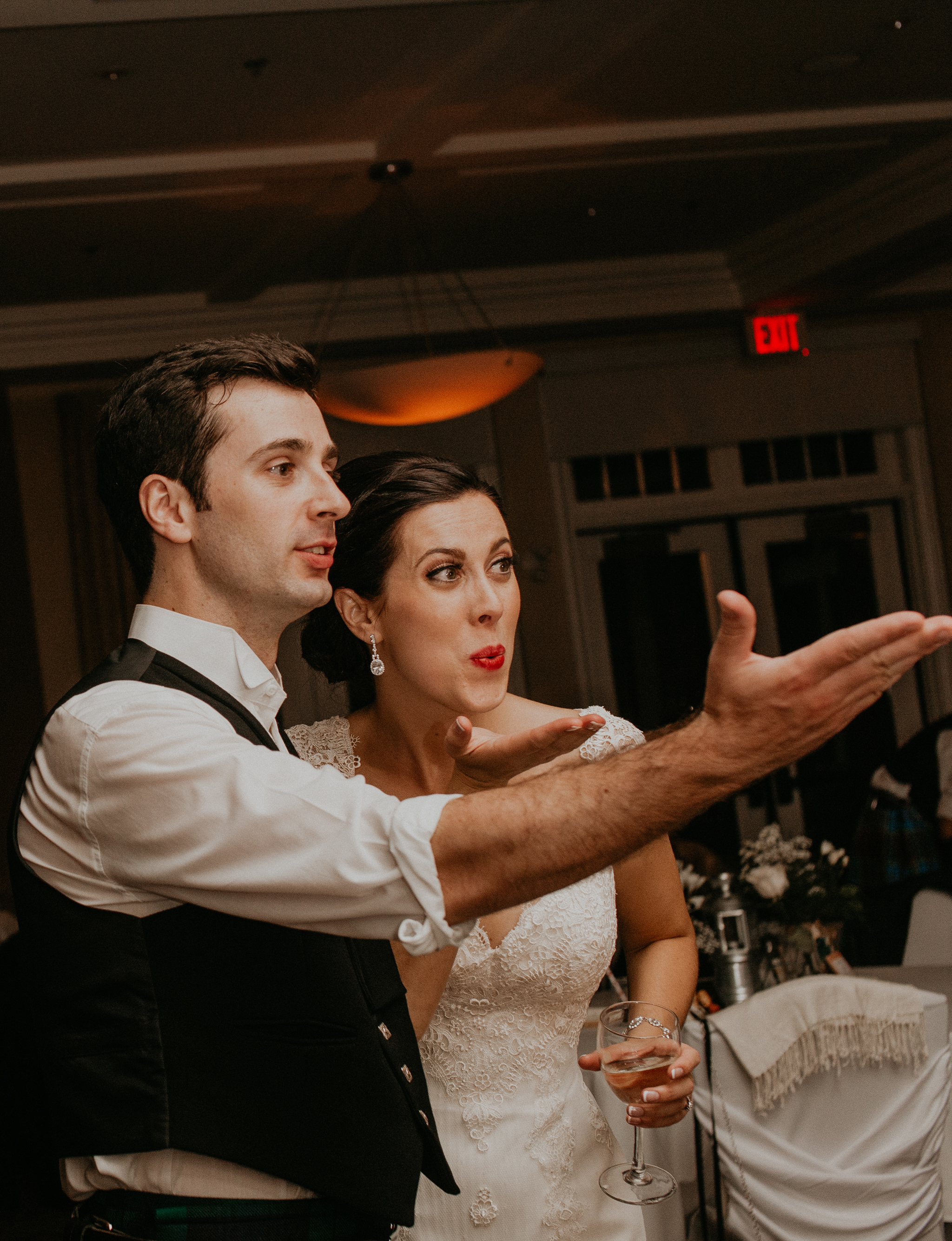 Candid moment of bride and groom blowing kiss at wedding reception