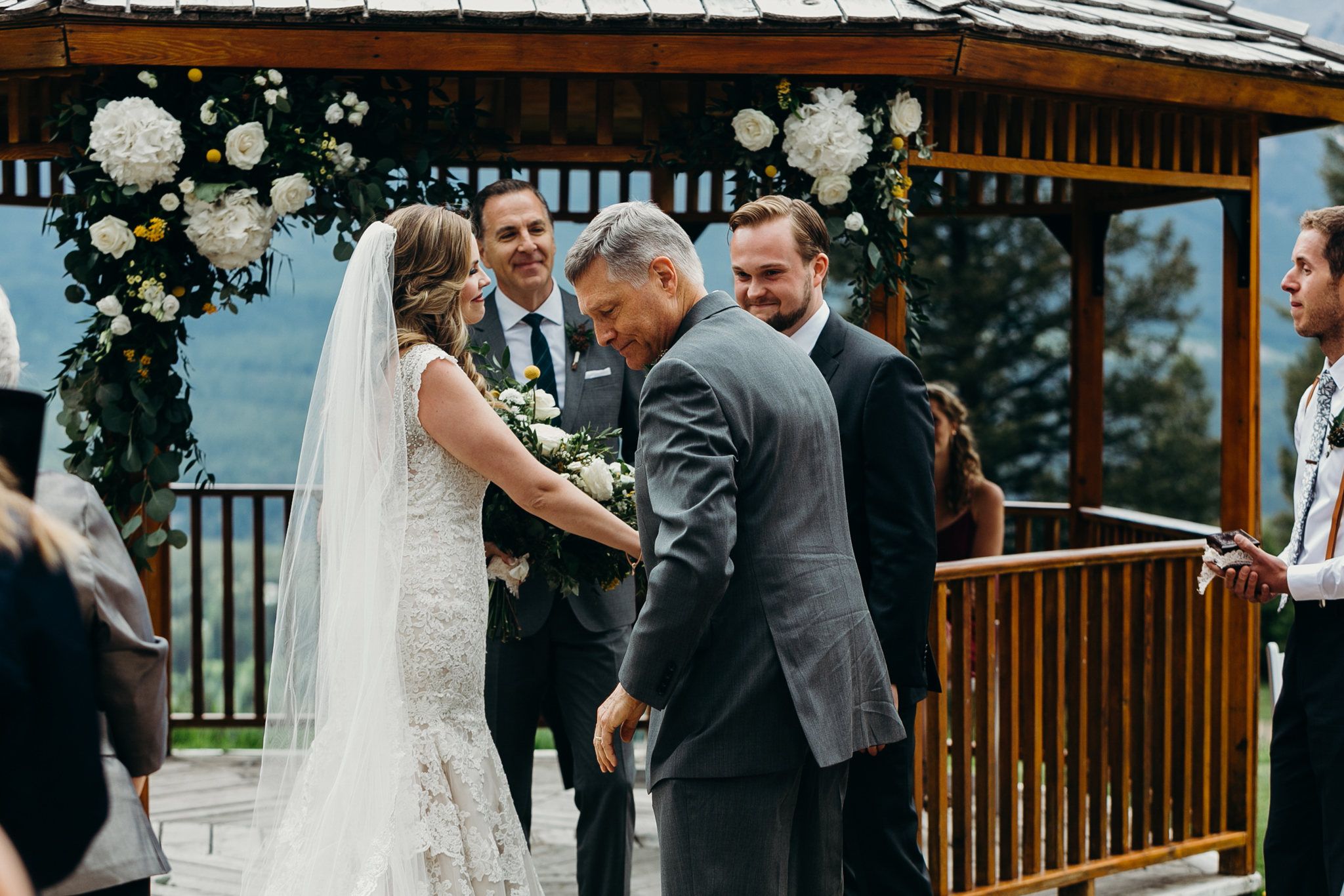 Father gives away bride at Silvertip Resort gazebo Canmore Alberta