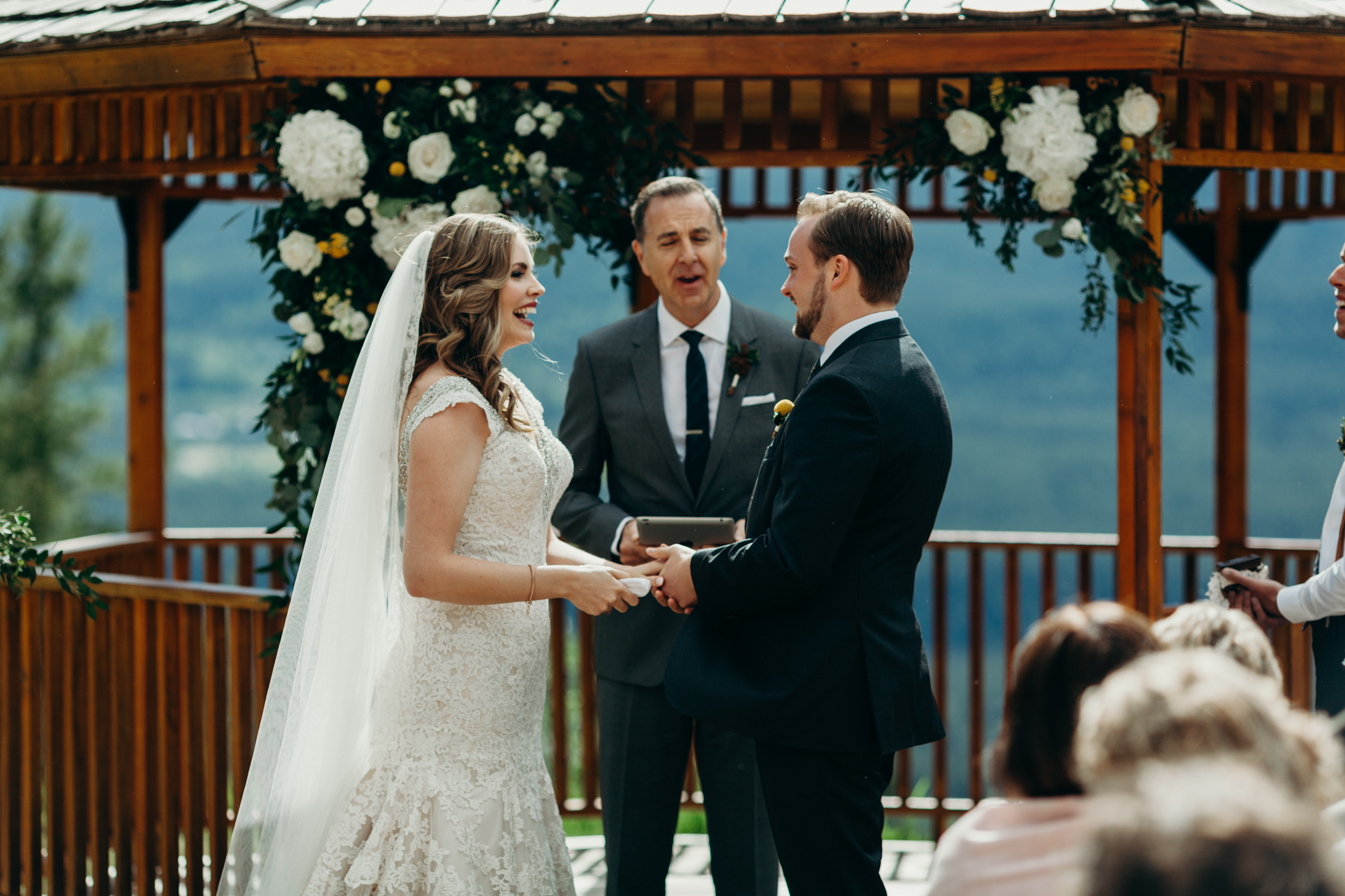 Bride and groom in front of gazebo at Silvertip Resort Canmore Alberta