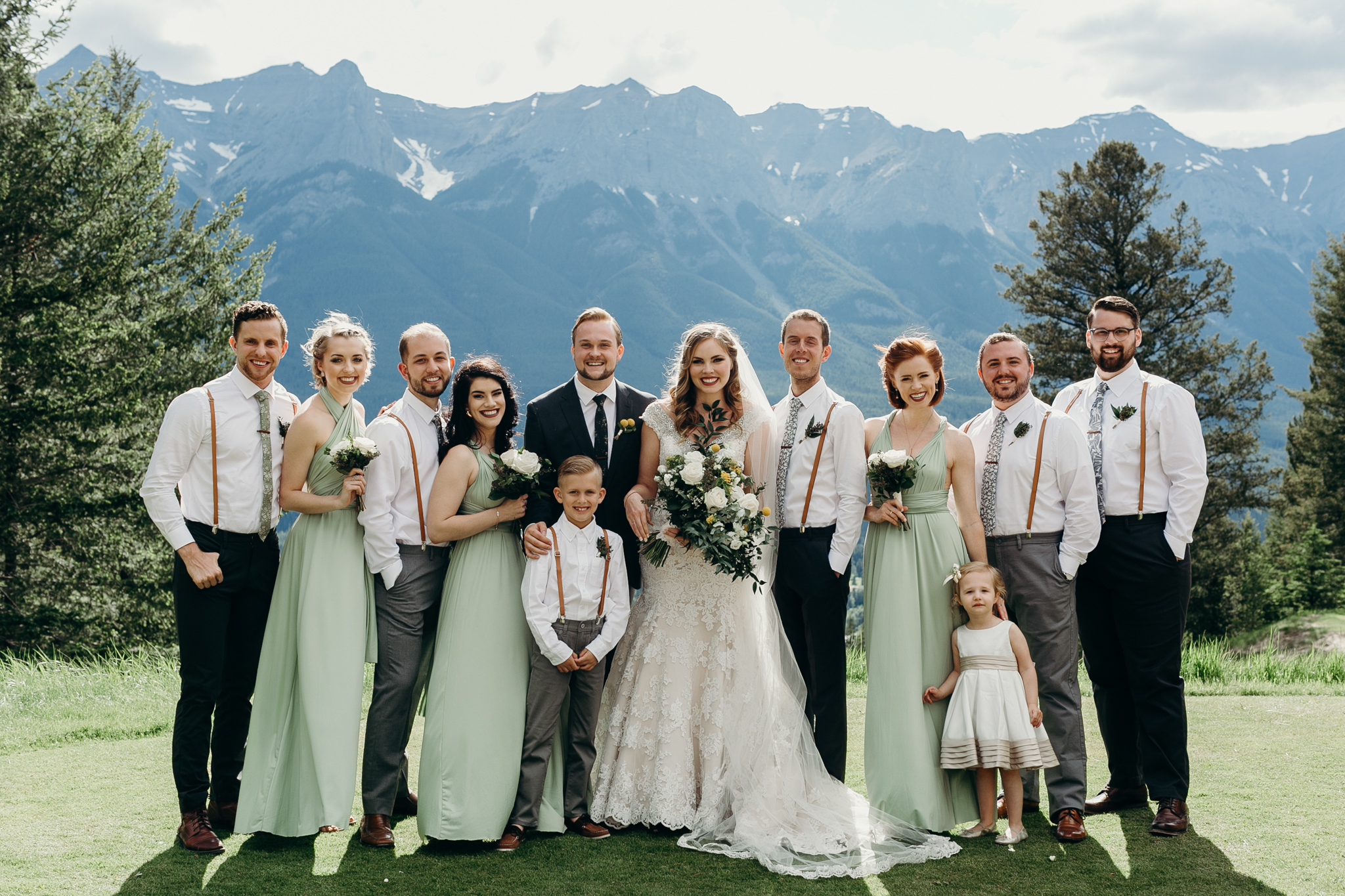 Wedding party photo with mountains at Silvertip Resort destination wedding Canmore AB