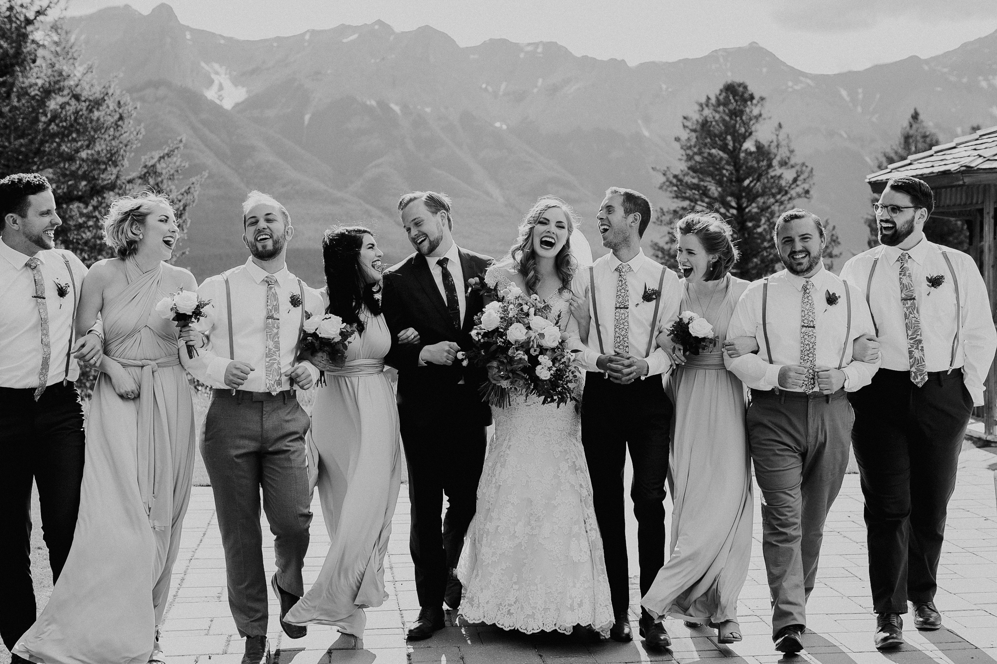 Wedding party photo with mountains at Silvertip Resort destination wedding Canmore AB