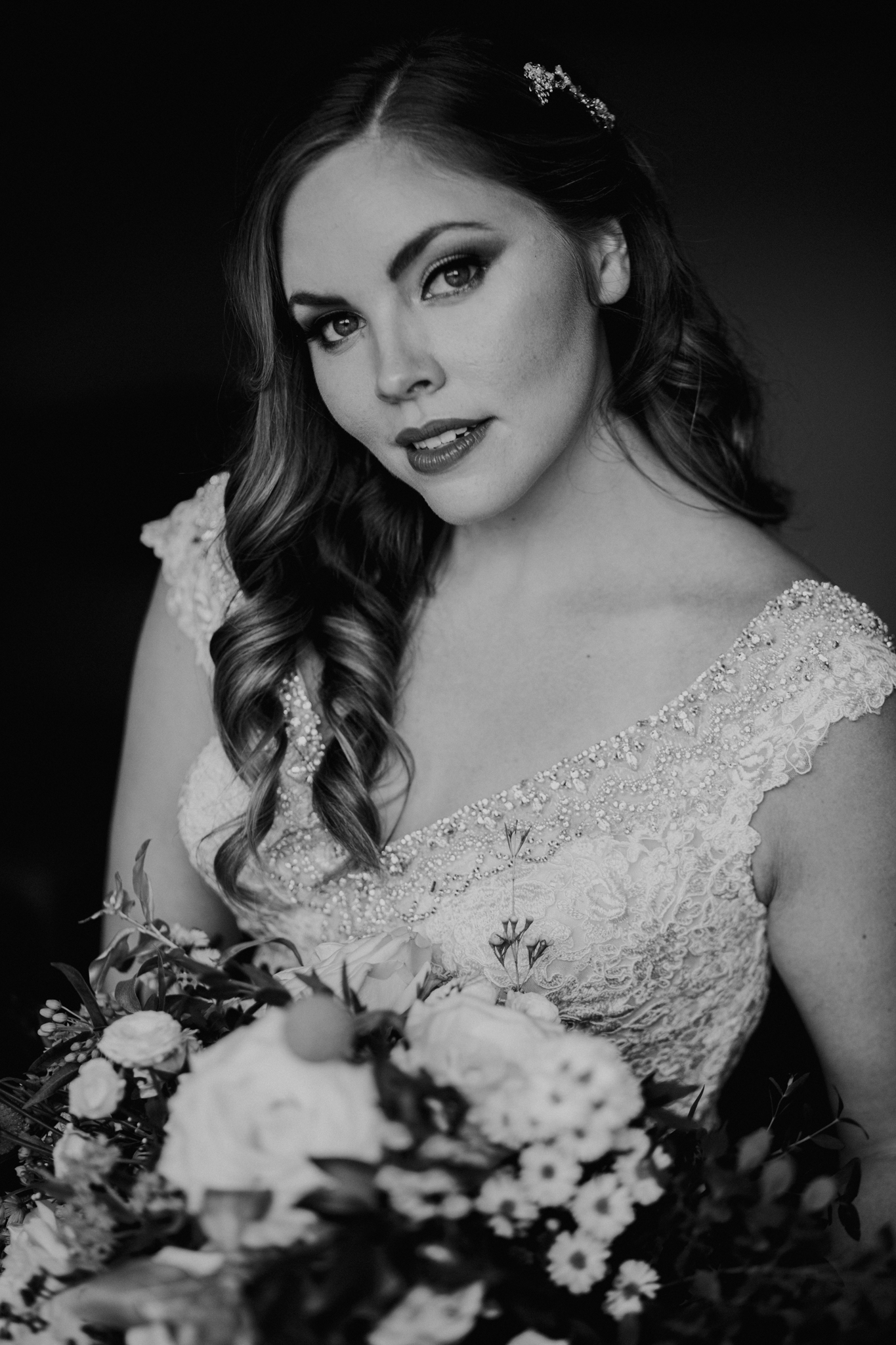 Black and white portrait of bride looking into camera holding flowers MN photographer
