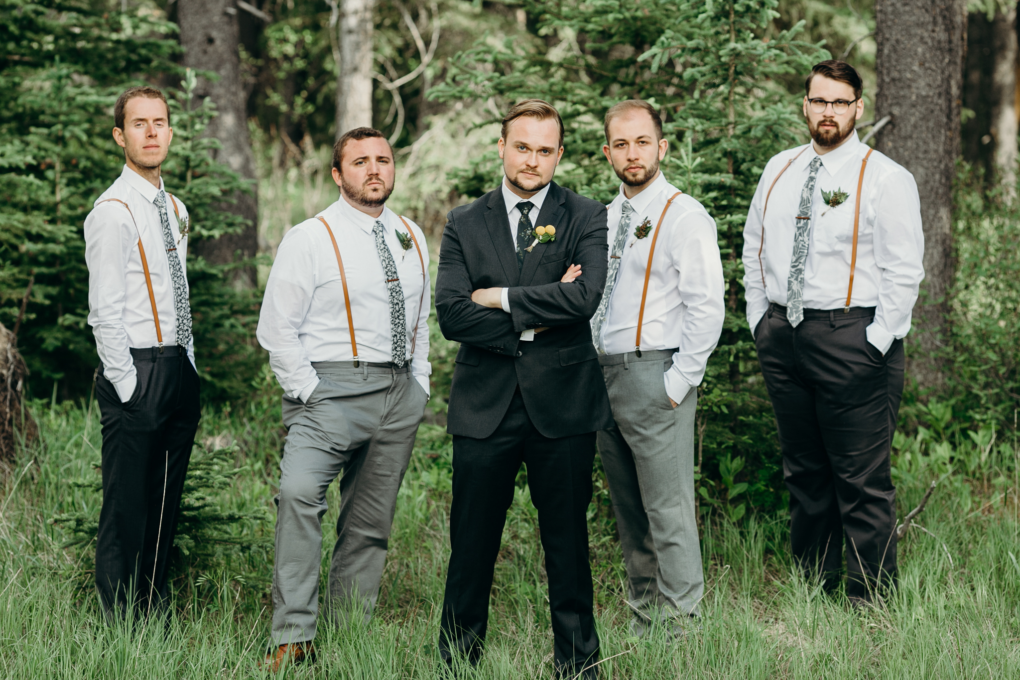 Groomsmen pose for picture at Silvertip Resort destination wedding Canmore AB