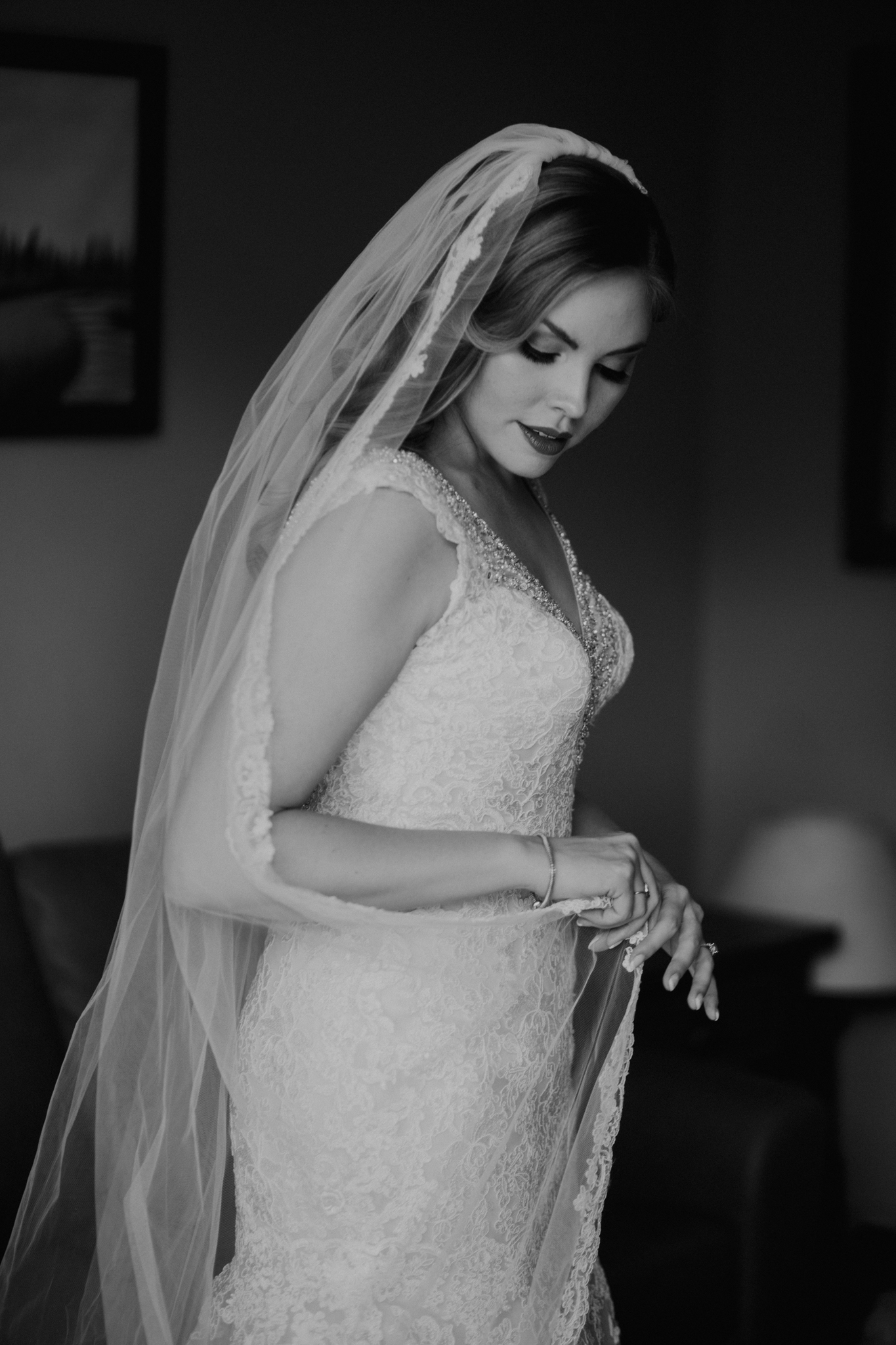 Bride fixing veil candid black and white photograph