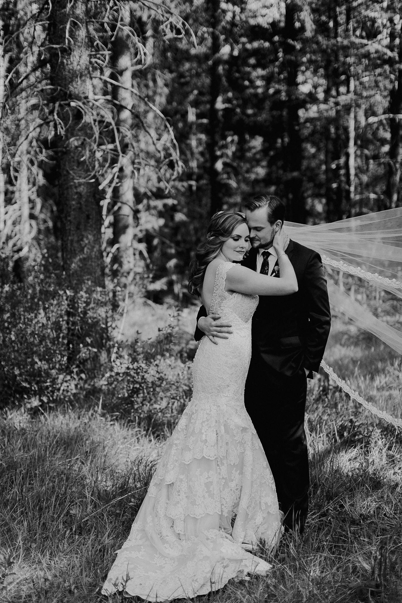 Bride poses for photo in black and white portrait at Silvertip Resort Canmore destination wedding