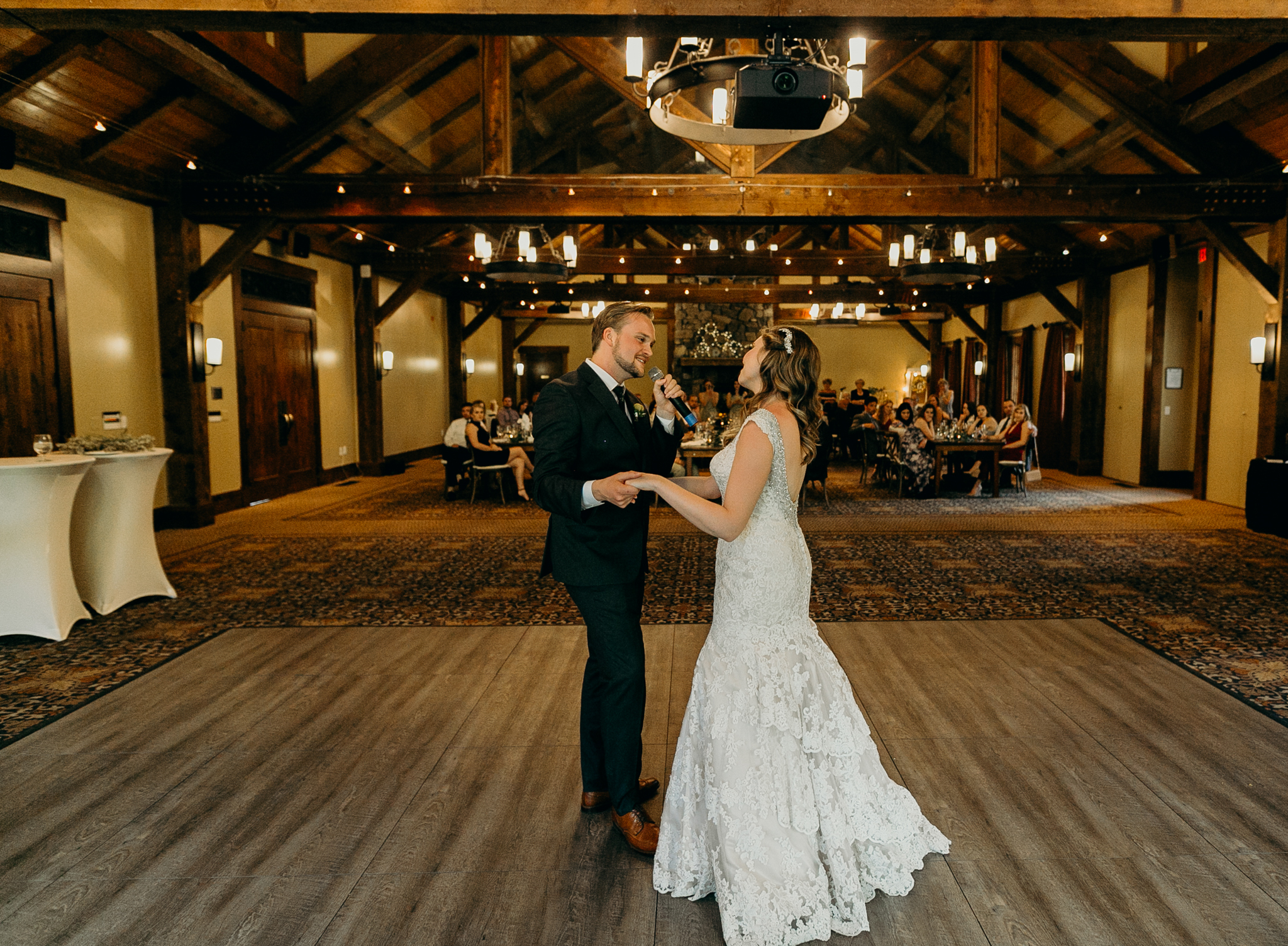 Bride and groom dance during wedding reception at Silvertip Resort in Canmore Alberta romantic wedding photograph MN