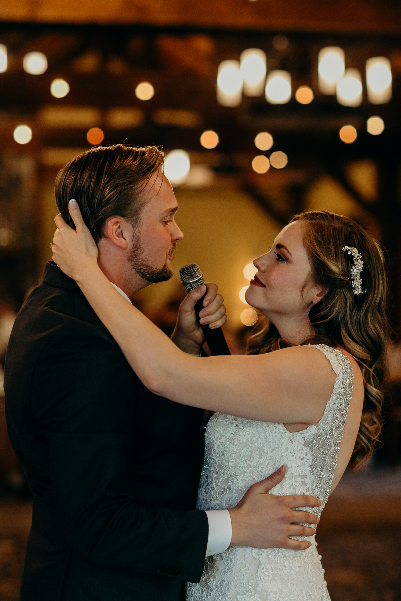 Bride and groom dance during wedding reception at Silvertip Resort in Canmore Alberta romantic wedding photograph MN