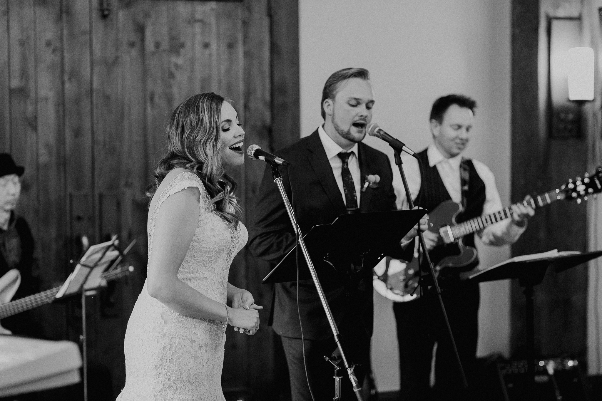 Bride and groom sing at wedding reception candid documentary photographer MN