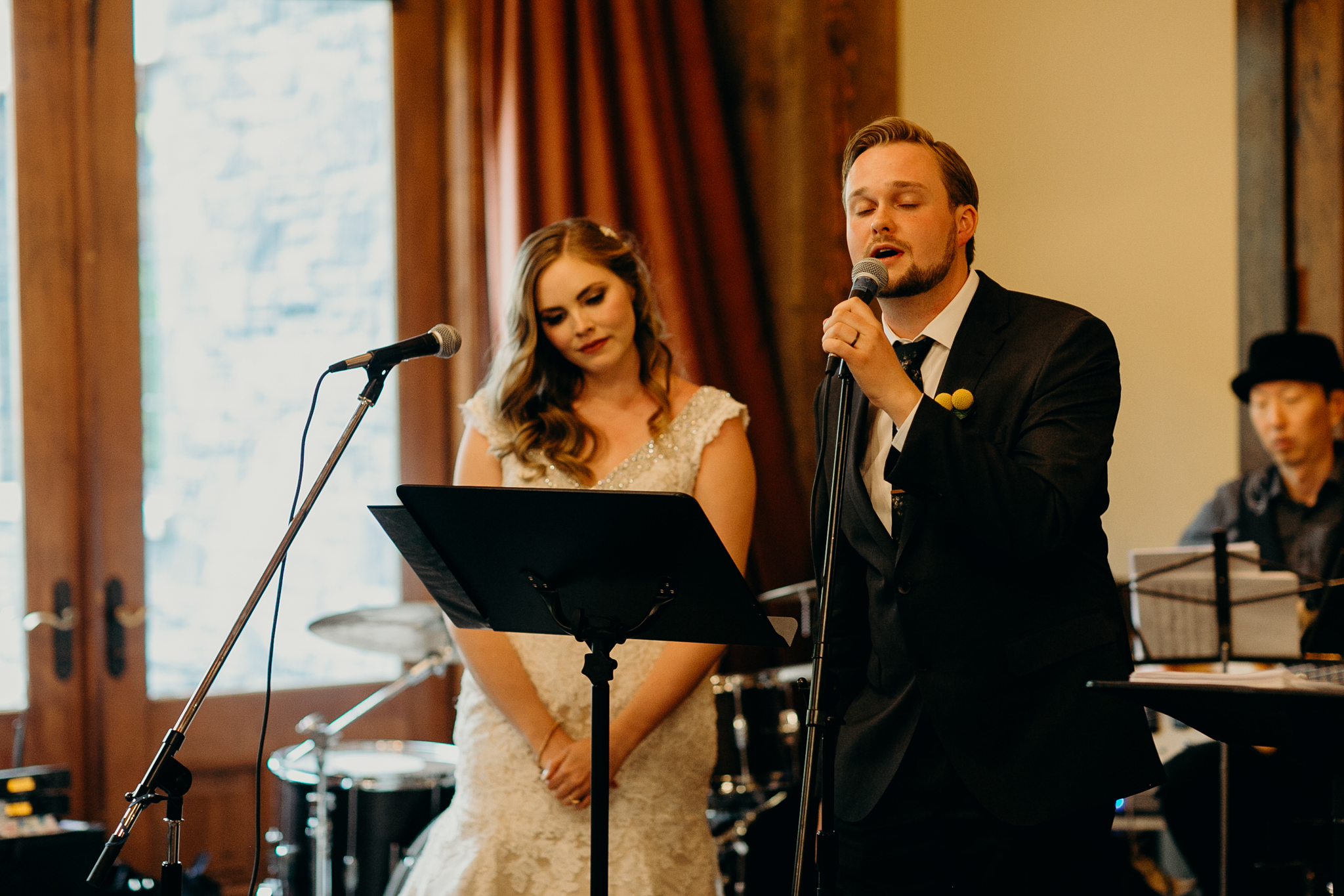 Bride and groom sing at wedding reception candid documentary photographer MN
