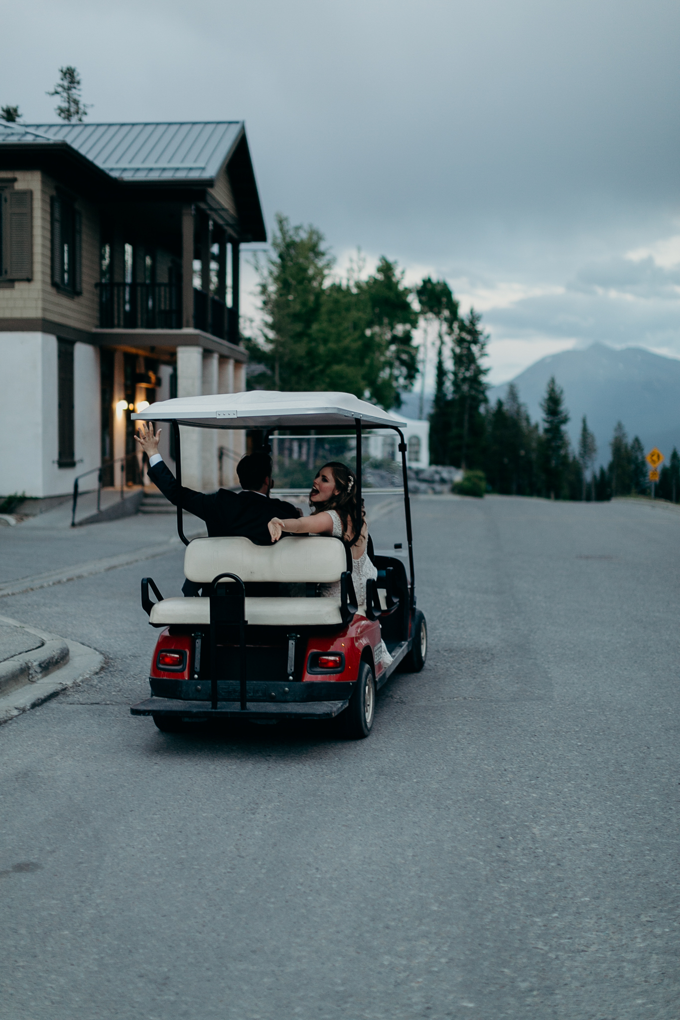 bride and groom leave Silvertip resort reception in golf cart