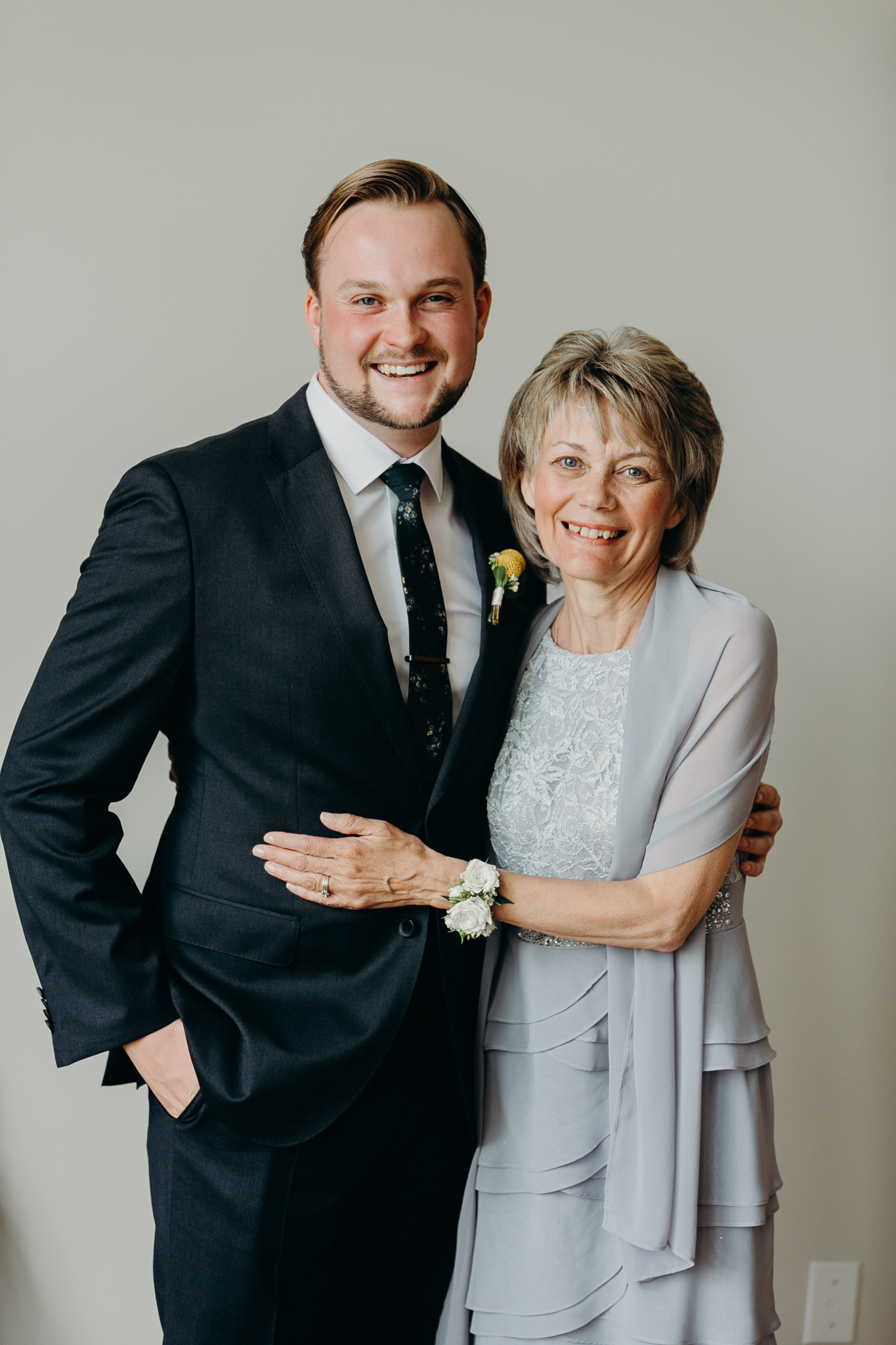 Portrait of groom and his mother smiling and embracing family wedding photography MN